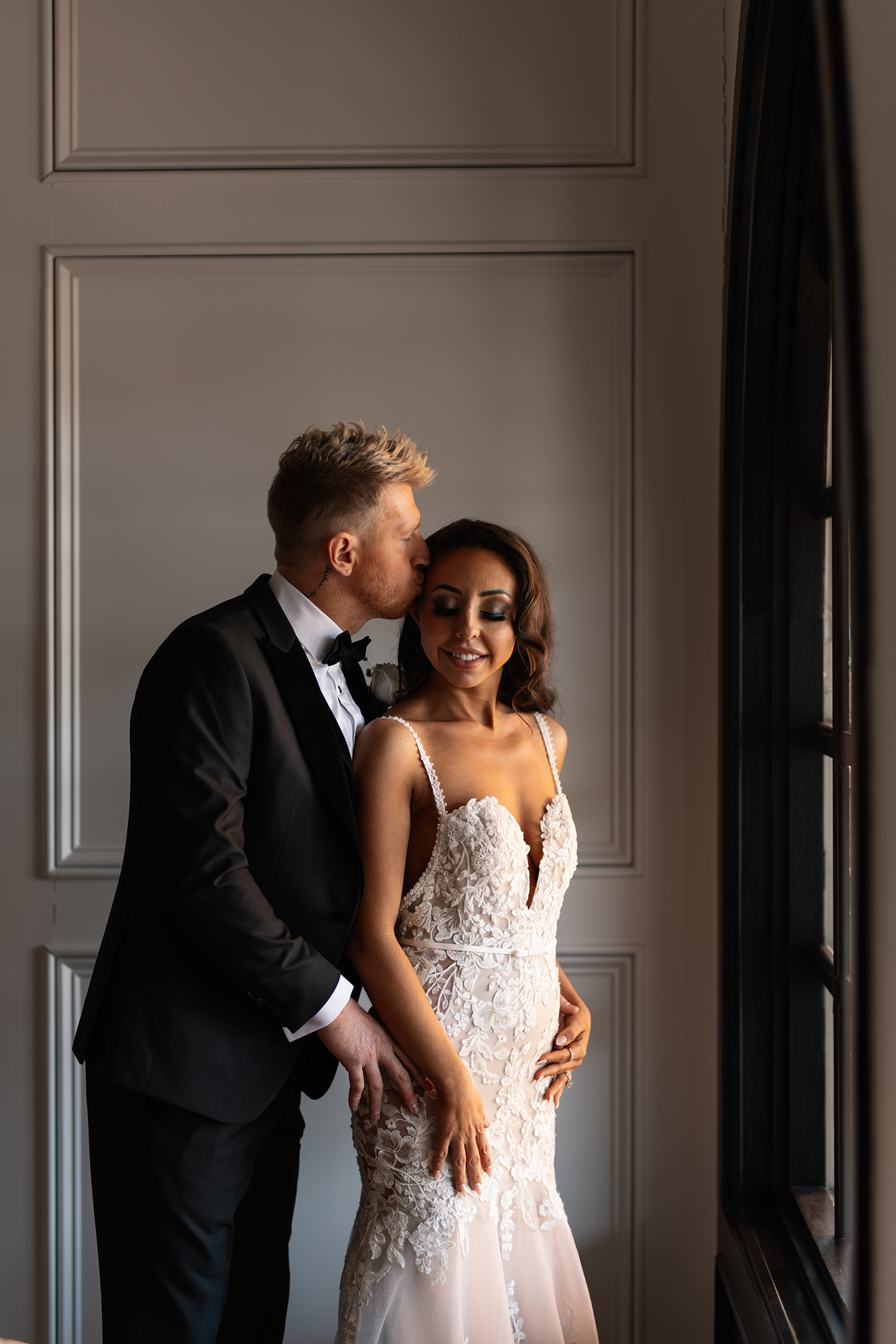 couple under twinkly light wedding arch brick wall olympic south side theater wedding venue cedar rapids