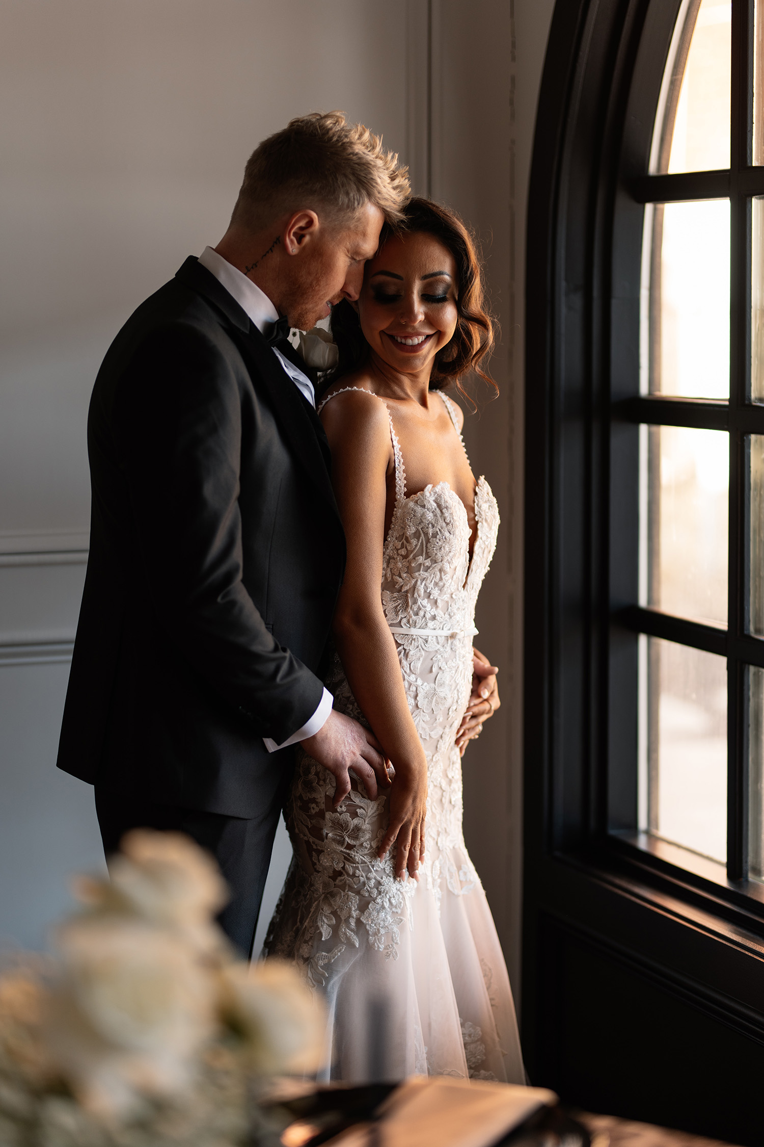 couple under twinkly light wedding arch brick wall olympic south side theater wedding venue cedar rapids