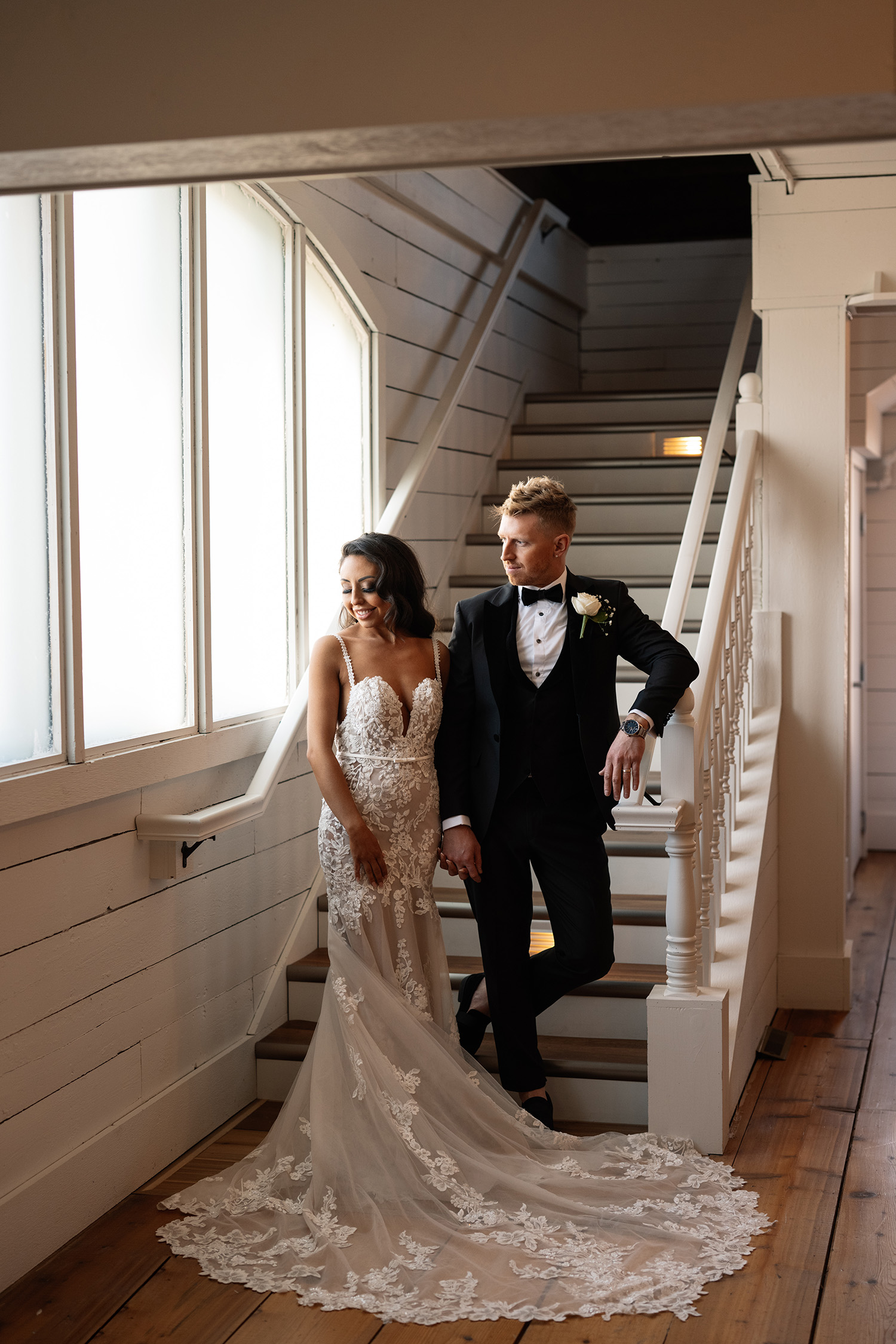 couple under twinkly light wedding arch brick wall olympic south side theater wedding venue cedar rapids