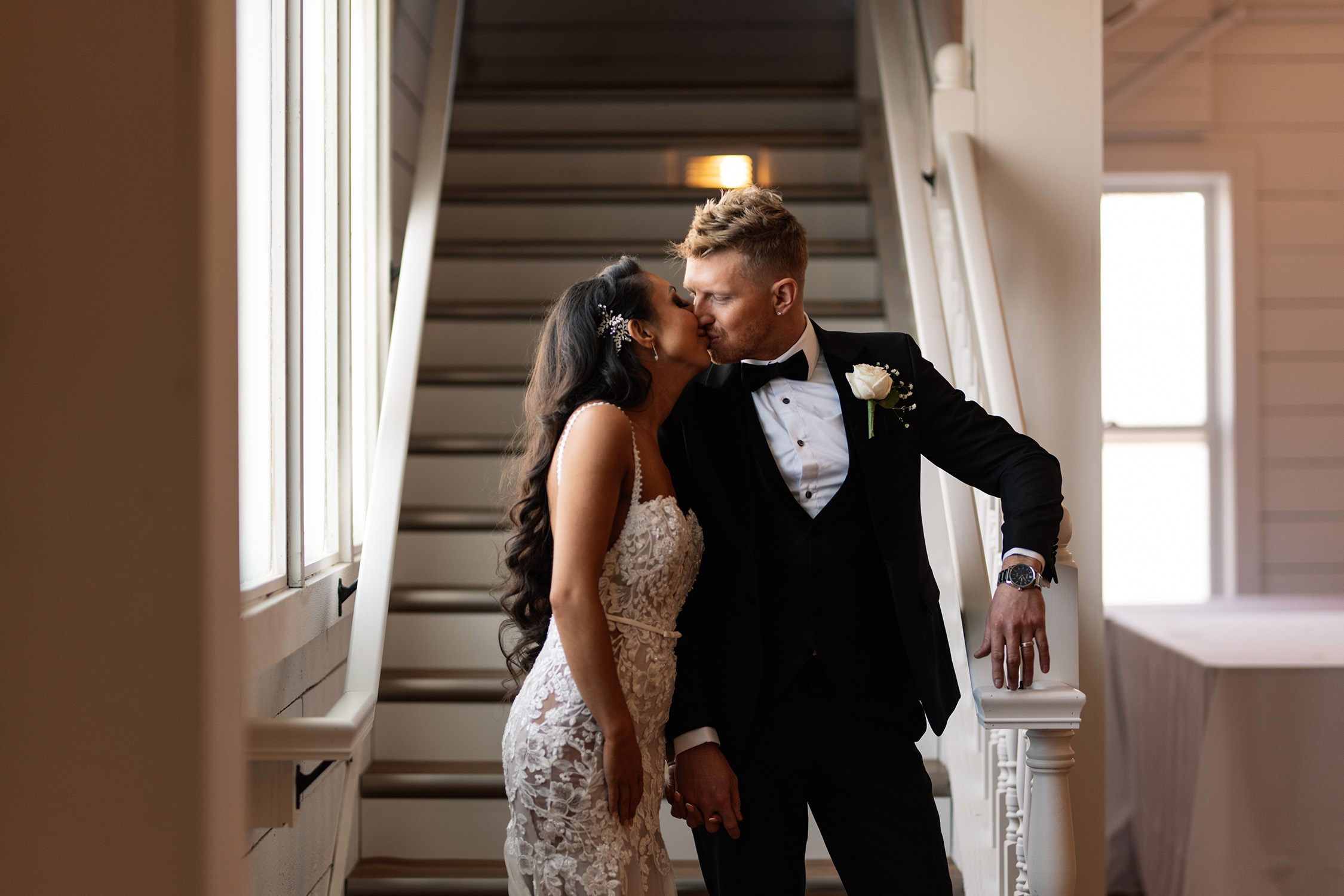 couple under twinkly light wedding arch brick wall olympic south side theater wedding venue cedar rapids