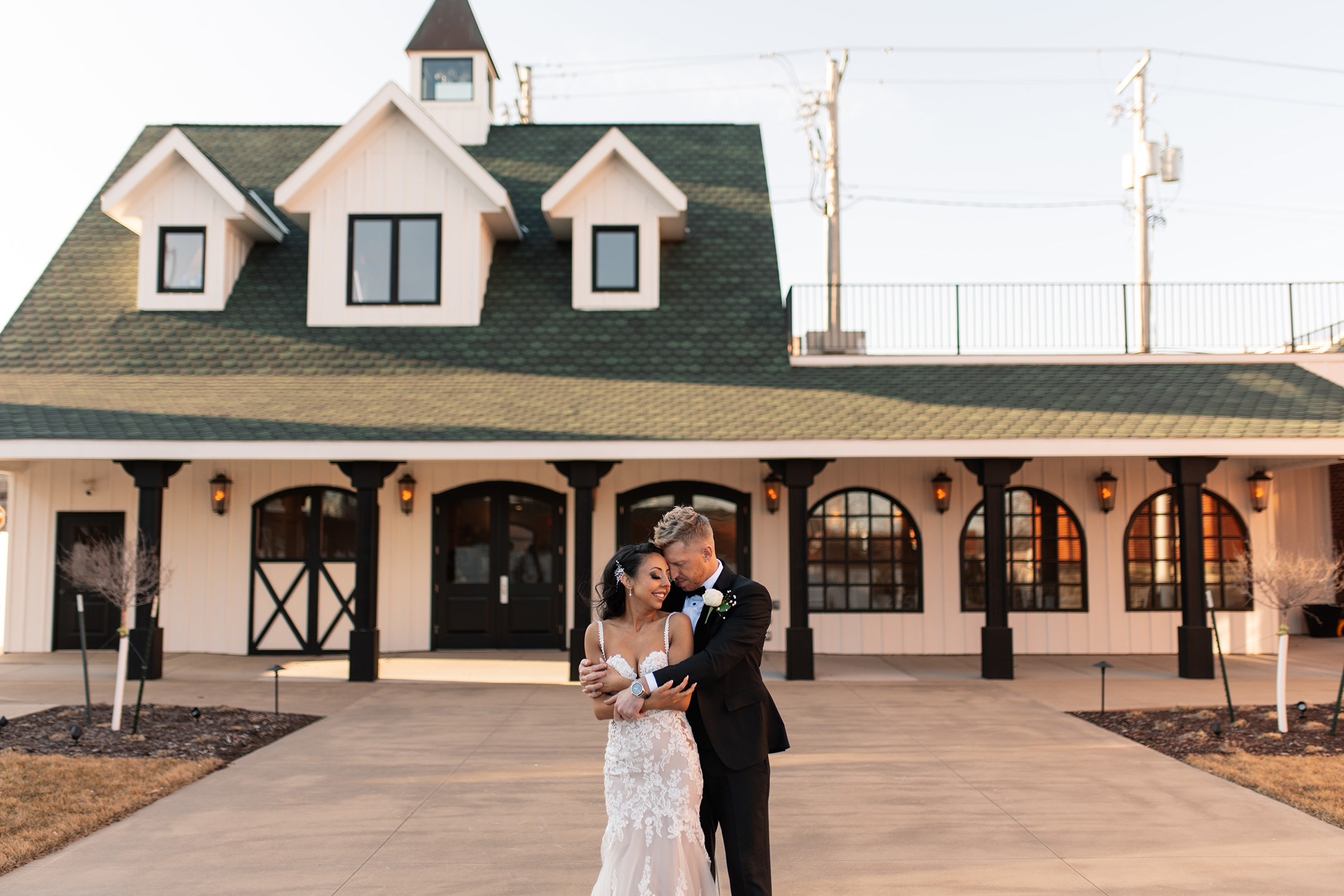 couple under twinkly light wedding arch brick wall olympic south side theater wedding venue cedar rapids