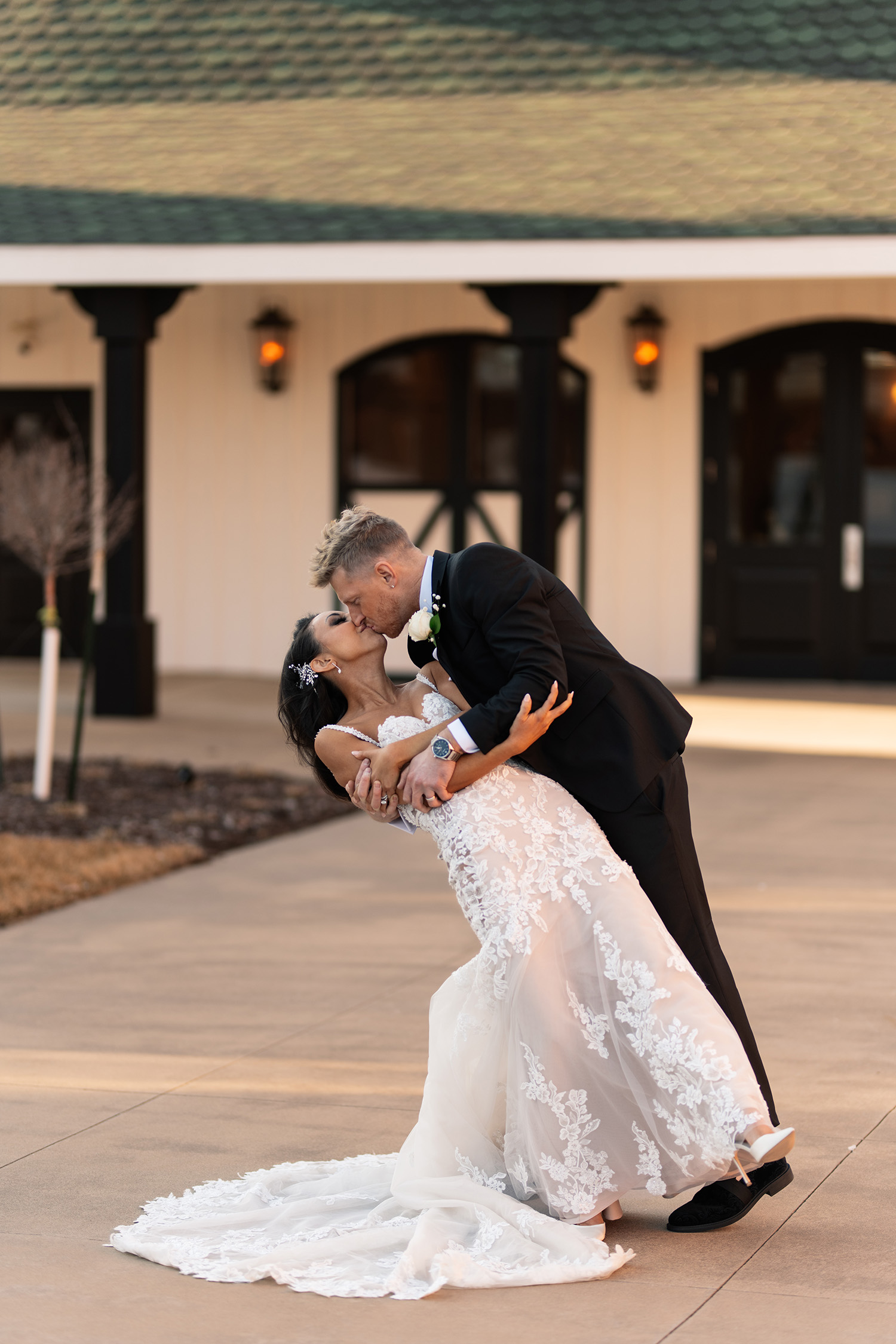 couple under twinkly light wedding arch brick wall olympic south side theater wedding venue cedar rapids