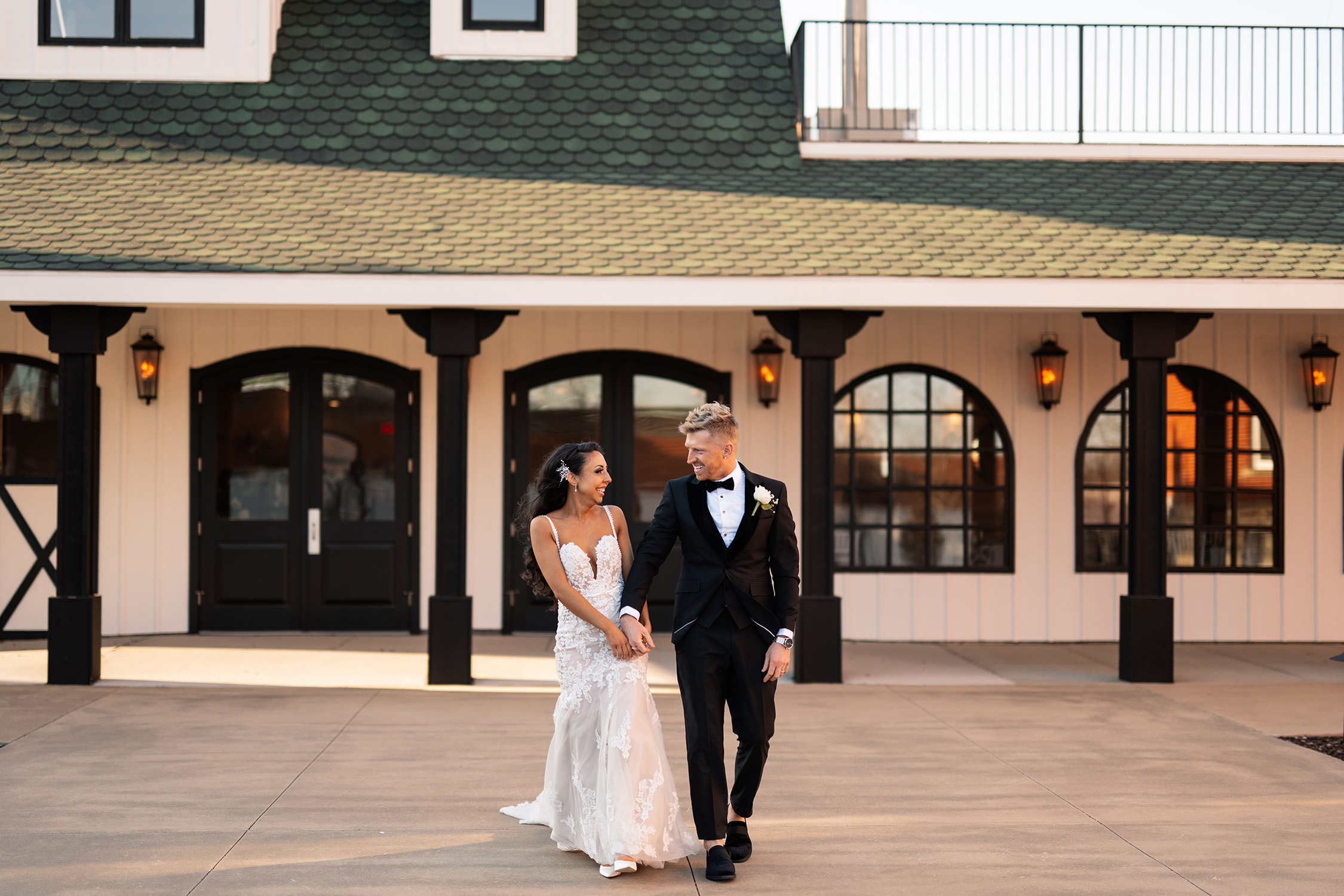 couple under twinkly light wedding arch brick wall olympic south side theater wedding venue cedar rapids