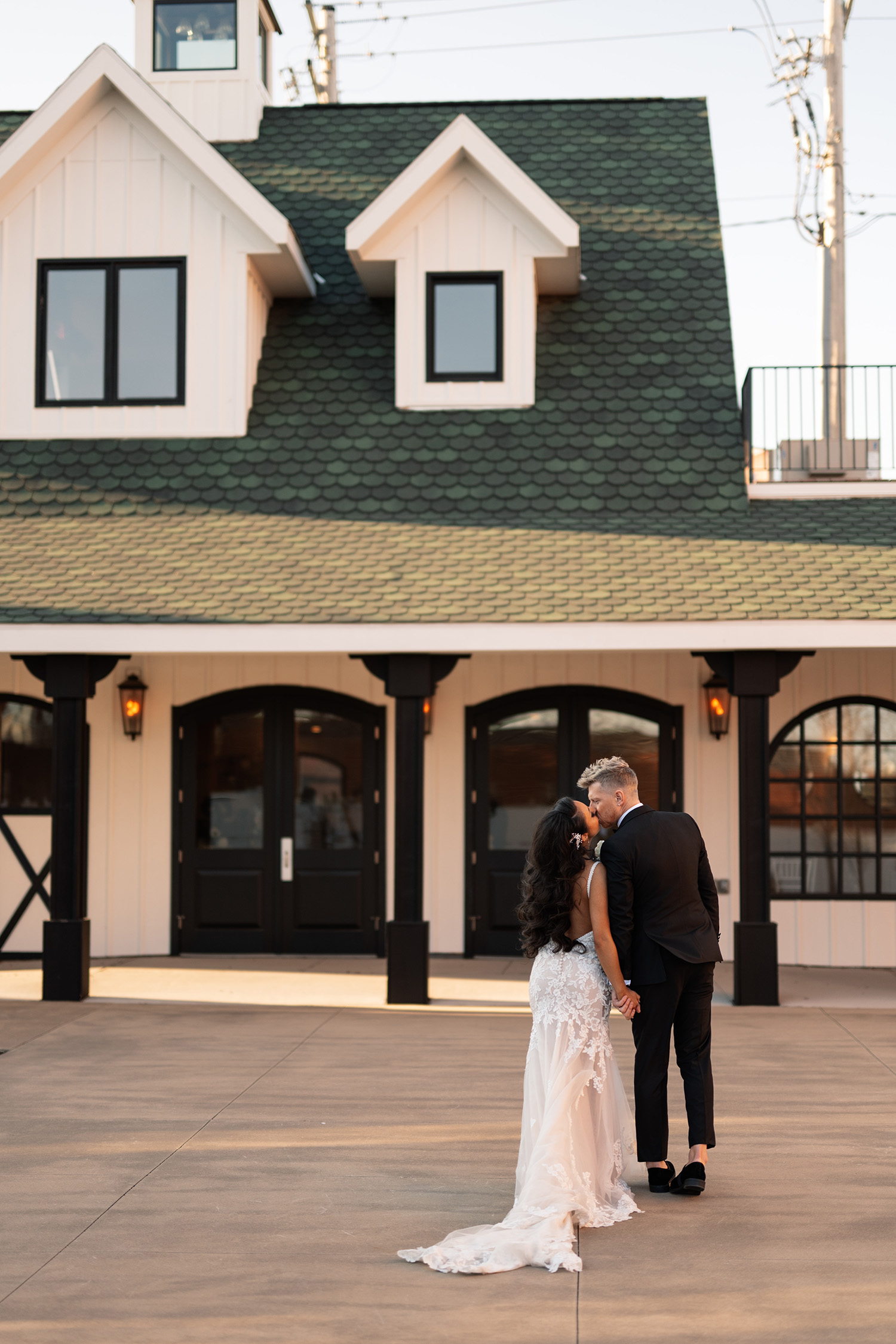 couple under twinkly light wedding arch brick wall olympic south side theater wedding venue cedar rapids