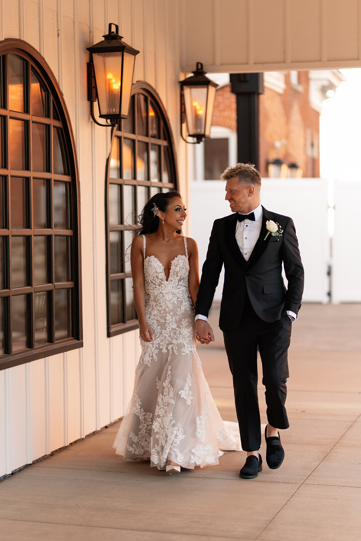 couple under twinkly light wedding arch brick wall olympic south side theater wedding venue cedar rapids