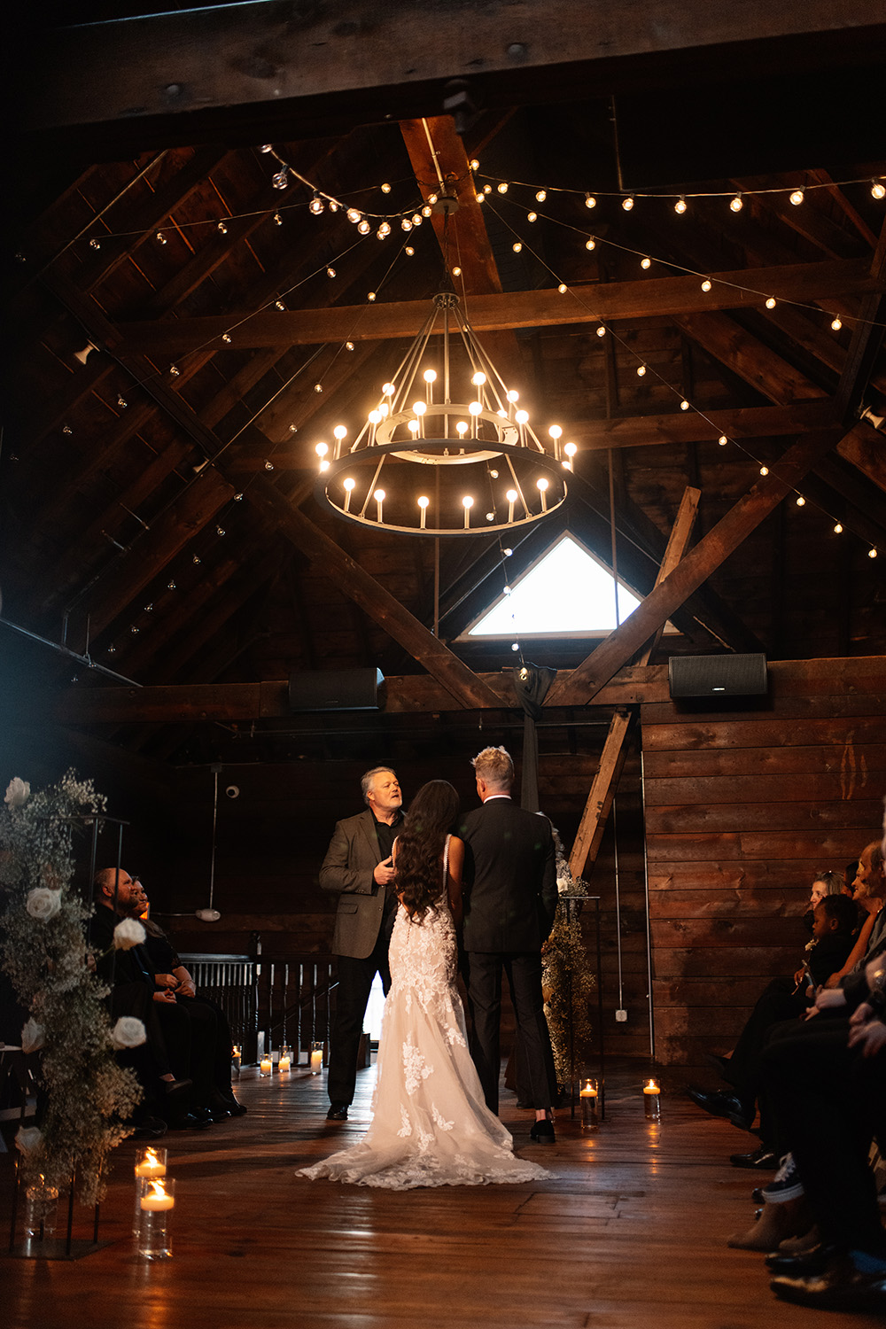 couple under twinkly light wedding arch brick wall olympic south side theater wedding venue cedar rapids