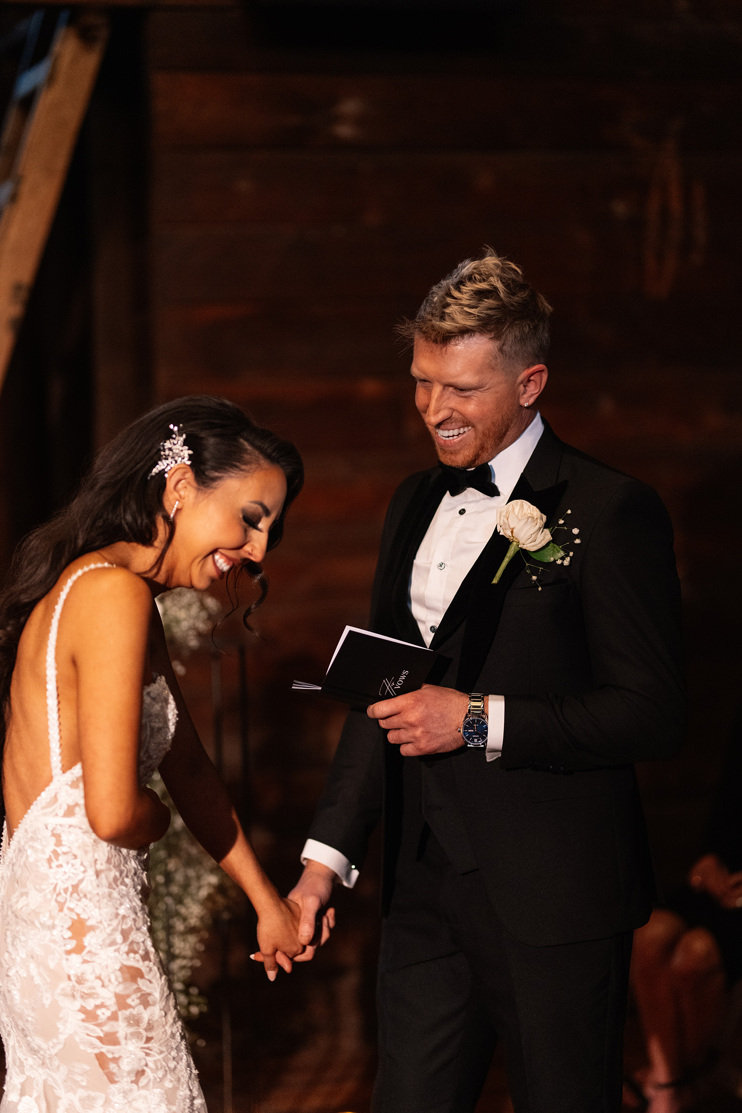 couple under twinkly light wedding arch brick wall olympic south side theater wedding venue cedar rapids