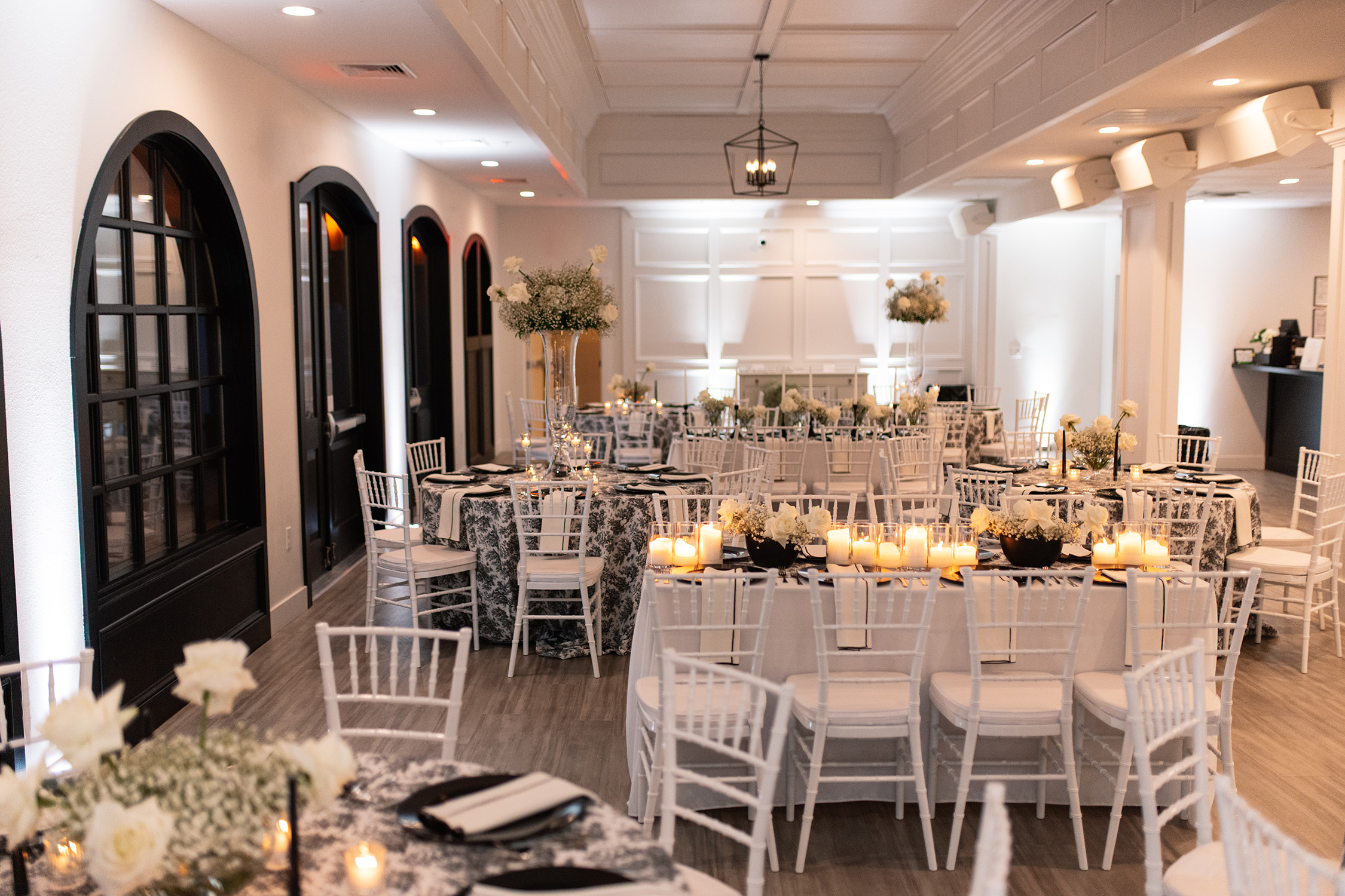 couple under twinkly light wedding arch brick wall olympic south side theater wedding venue cedar rapids