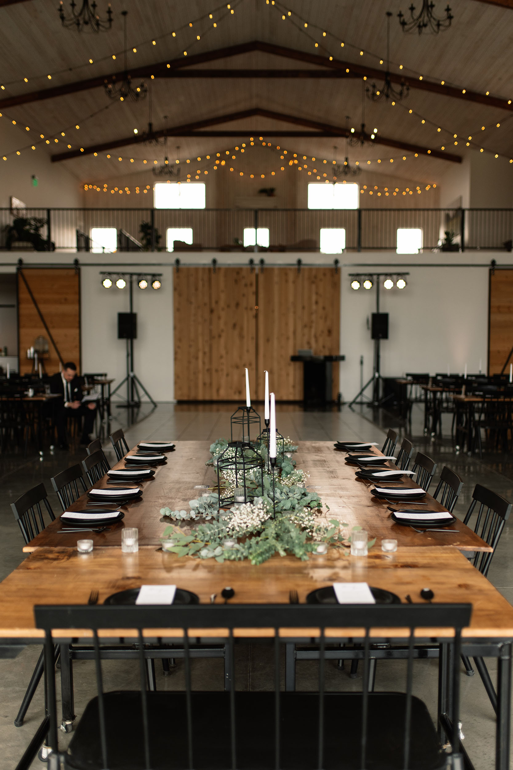 couple under twinkly light wedding arch brick wall olympic south side theater wedding venue cedar rapids