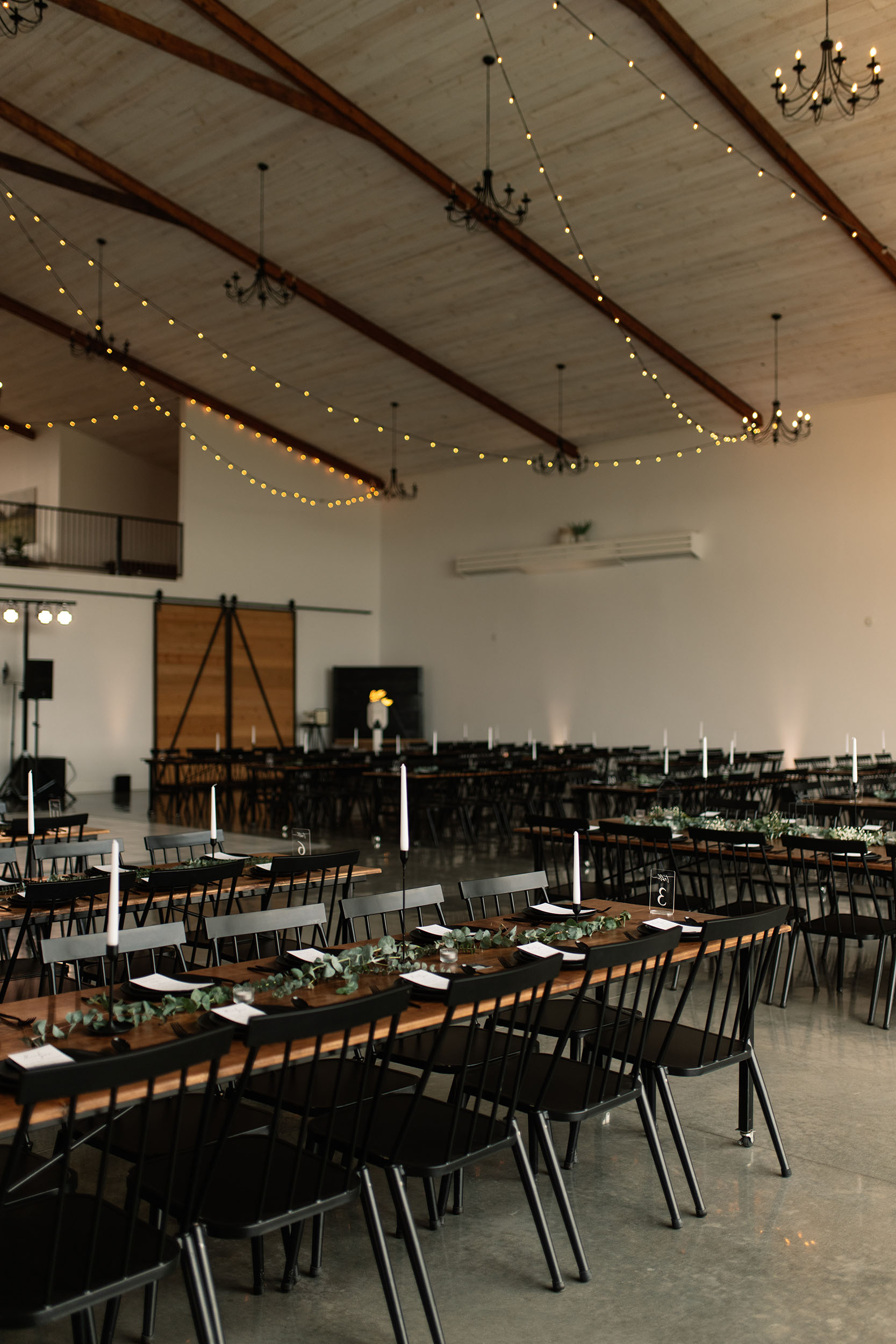 couple under twinkly light wedding arch brick wall olympic south side theater wedding venue cedar rapids