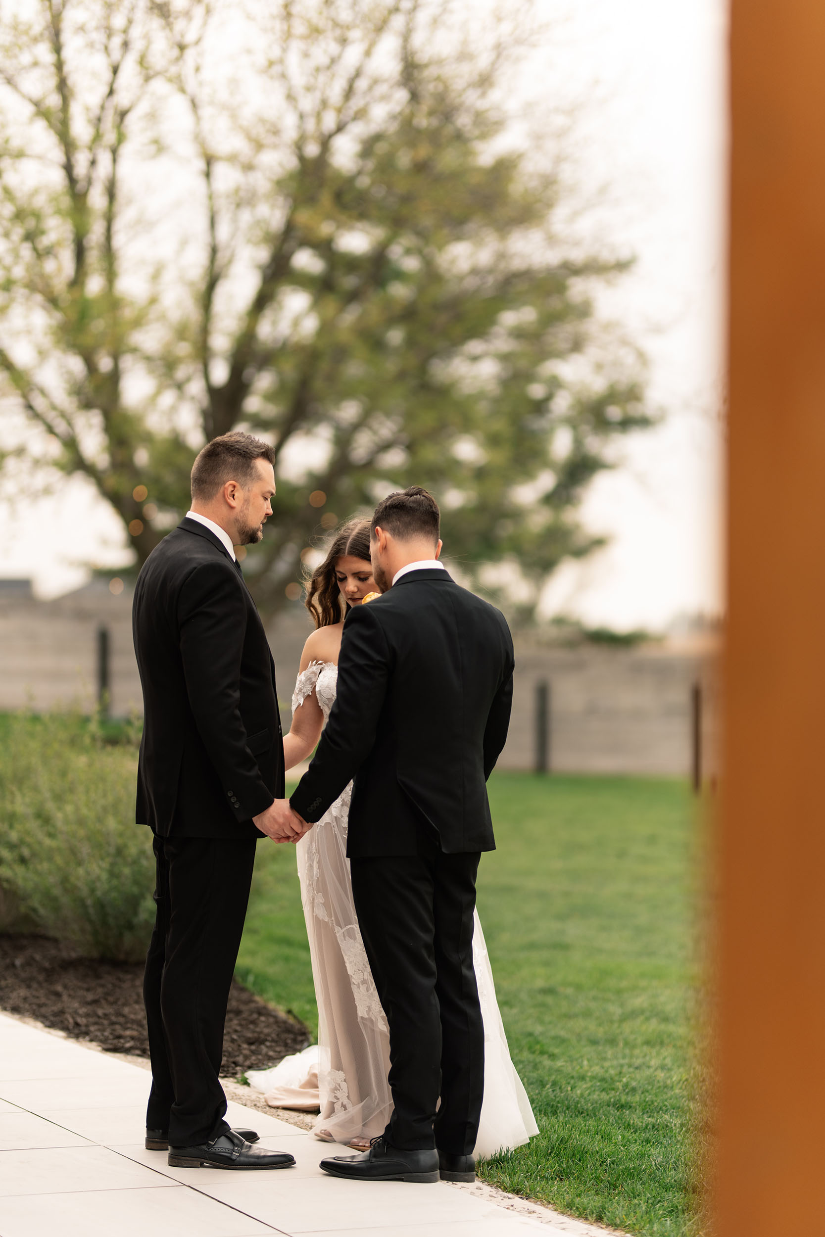 couple under twinkly light wedding arch brick wall olympic south side theater wedding venue cedar rapids