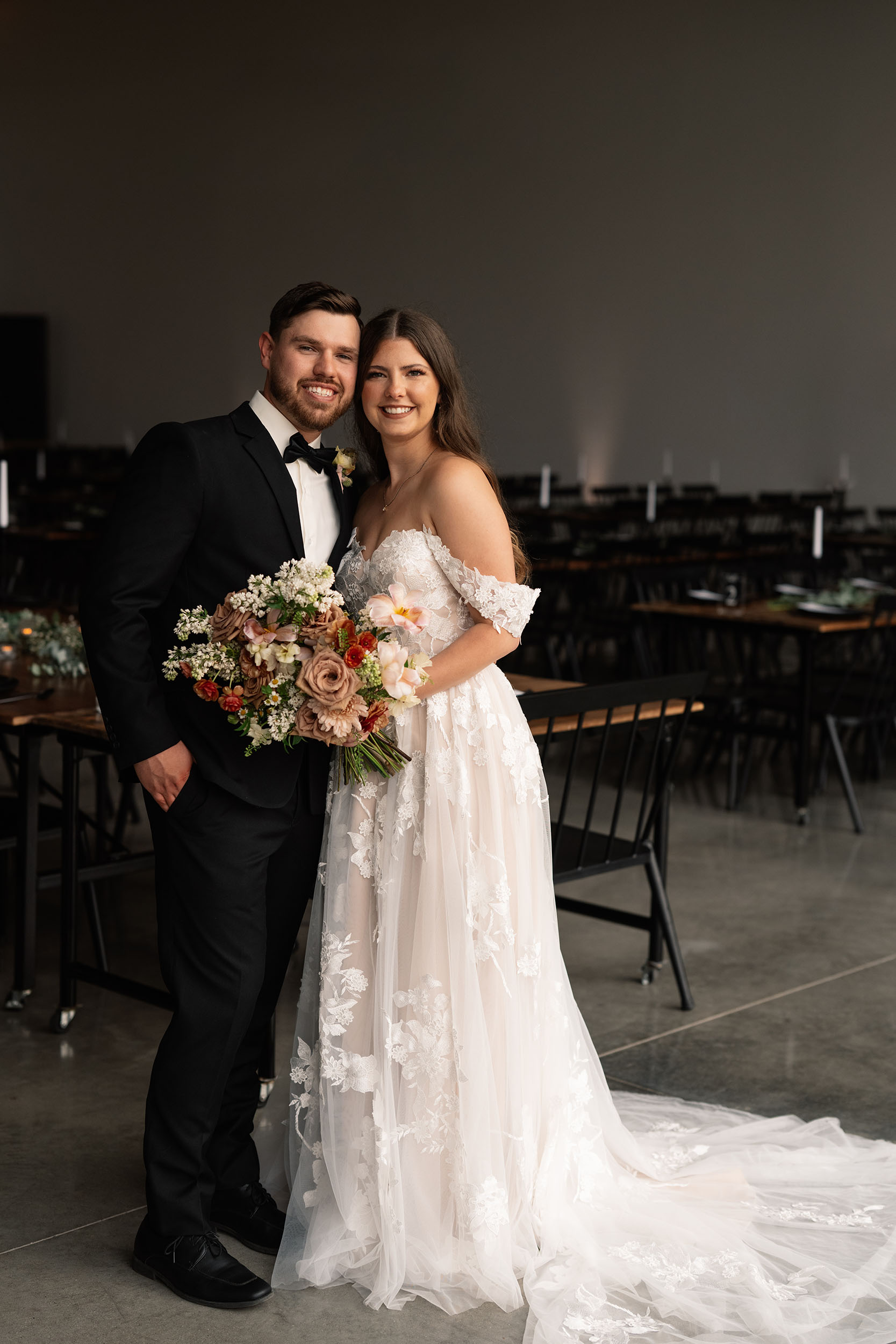 couple under twinkly light wedding arch brick wall olympic south side theater wedding venue cedar rapids