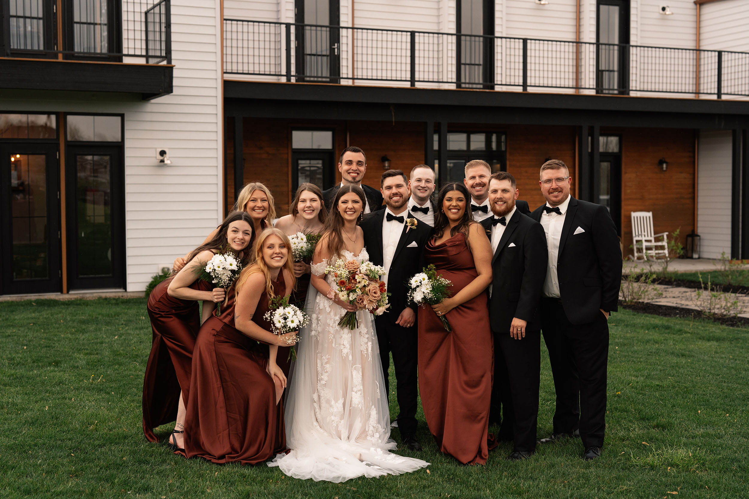 couple under twinkly light wedding arch brick wall olympic south side theater wedding venue cedar rapids