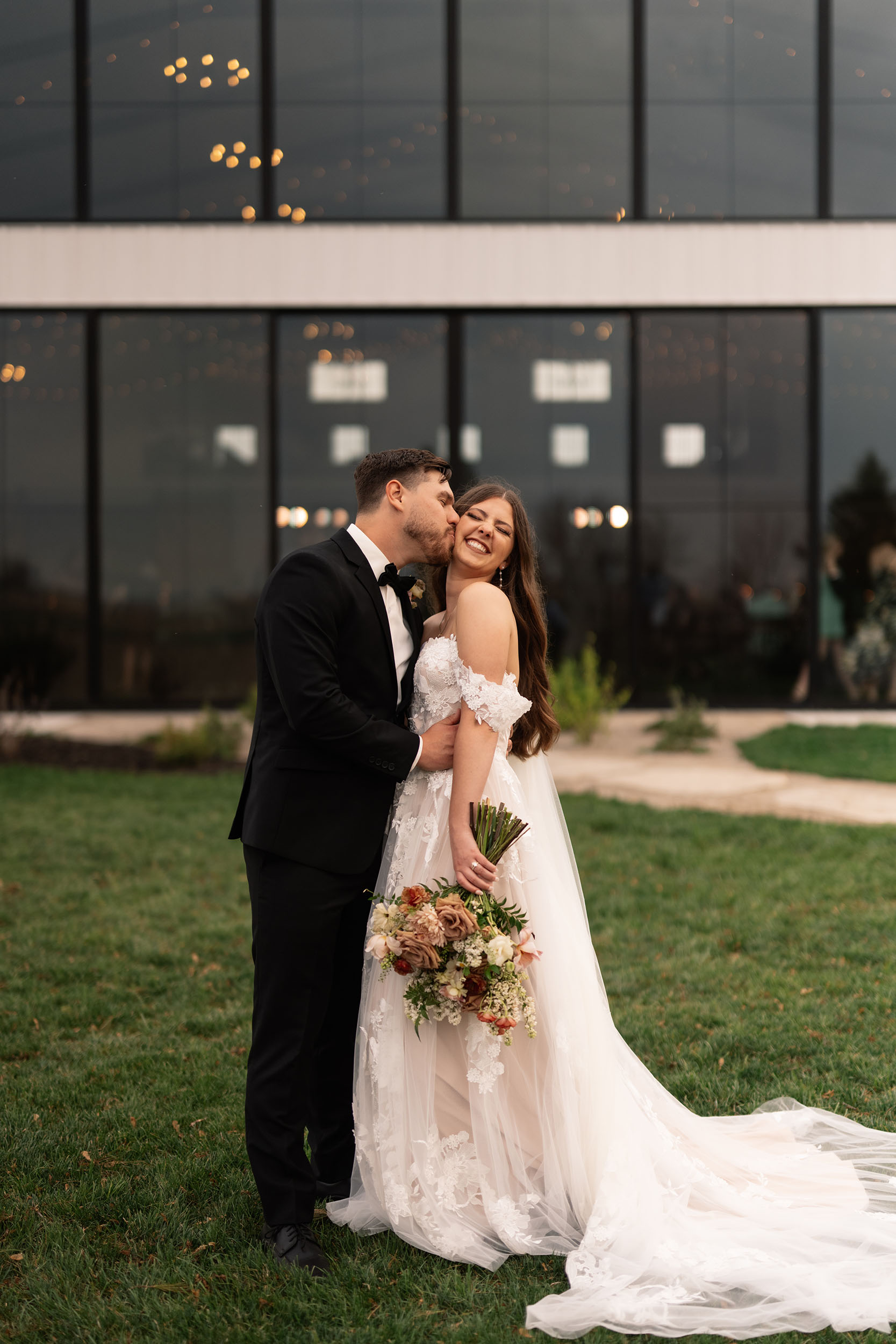 couple under twinkly light wedding arch brick wall olympic south side theater wedding venue cedar rapids