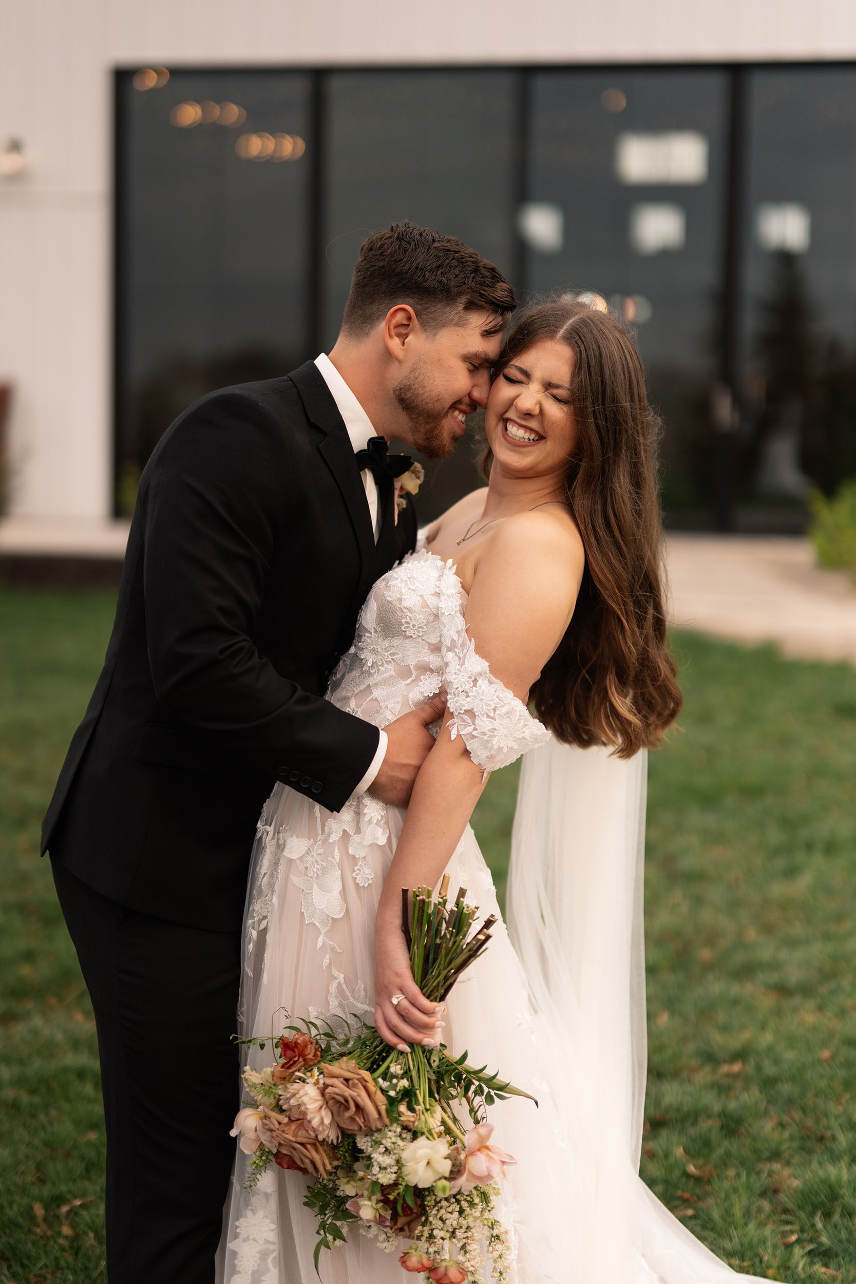 couple under twinkly light wedding arch brick wall olympic south side theater wedding venue cedar rapids