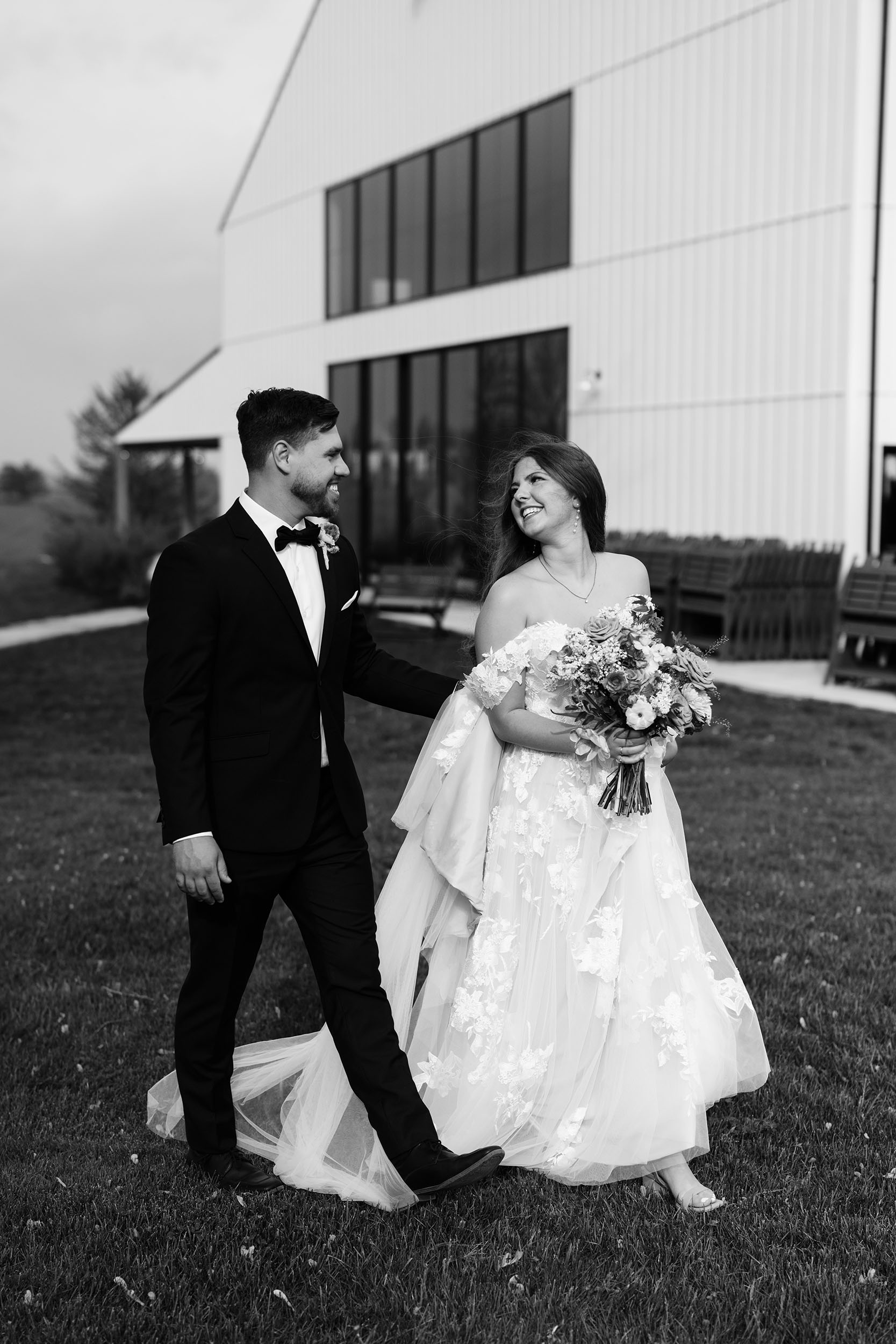 couple under twinkly light wedding arch brick wall olympic south side theater wedding venue cedar rapids