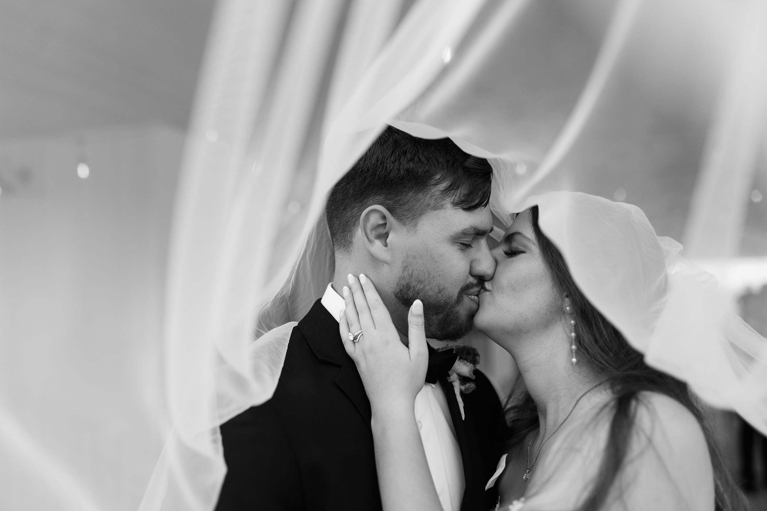 couple under twinkly light wedding arch brick wall olympic south side theater wedding venue cedar rapids