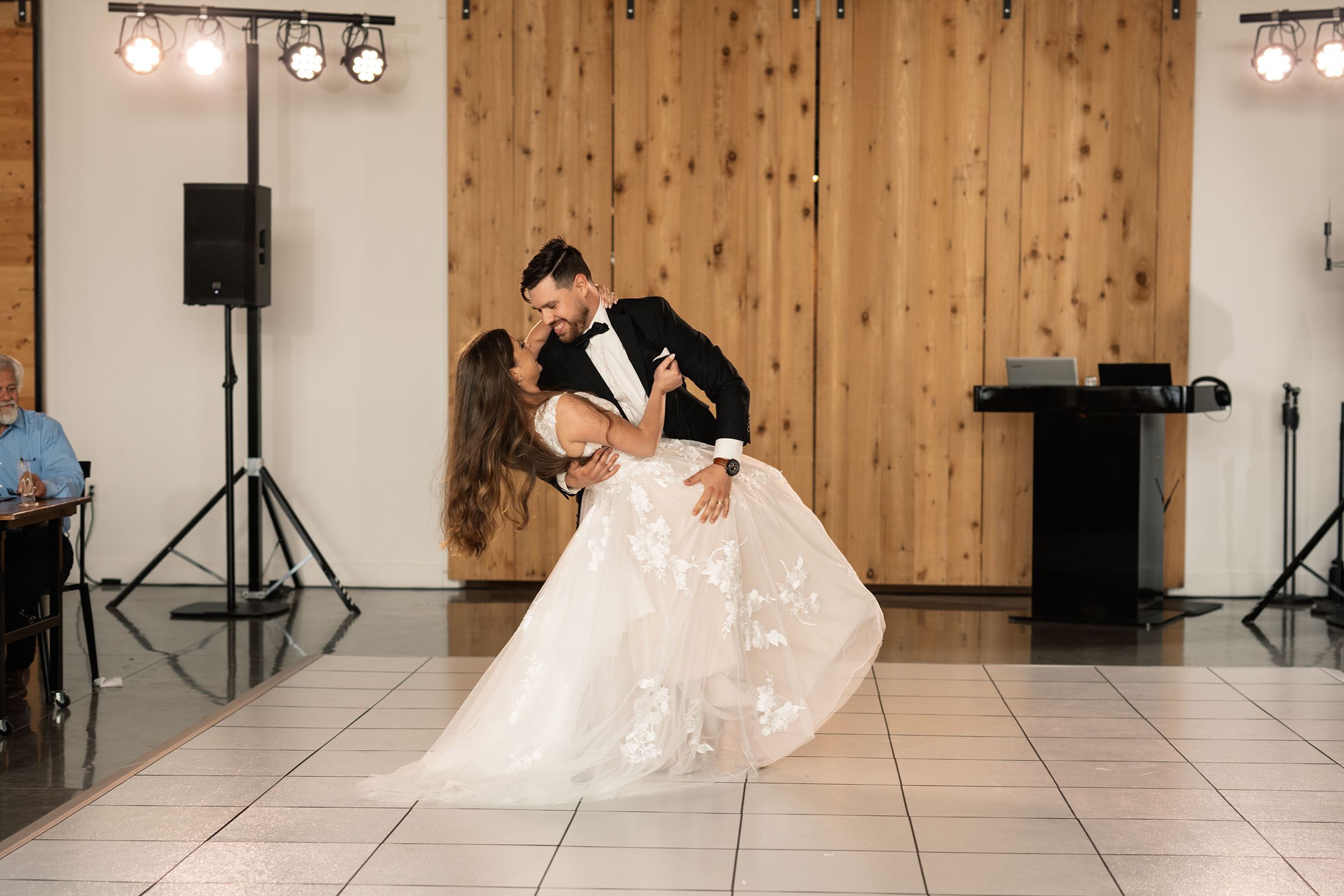 couple under twinkly light wedding arch brick wall olympic south side theater wedding venue cedar rapids