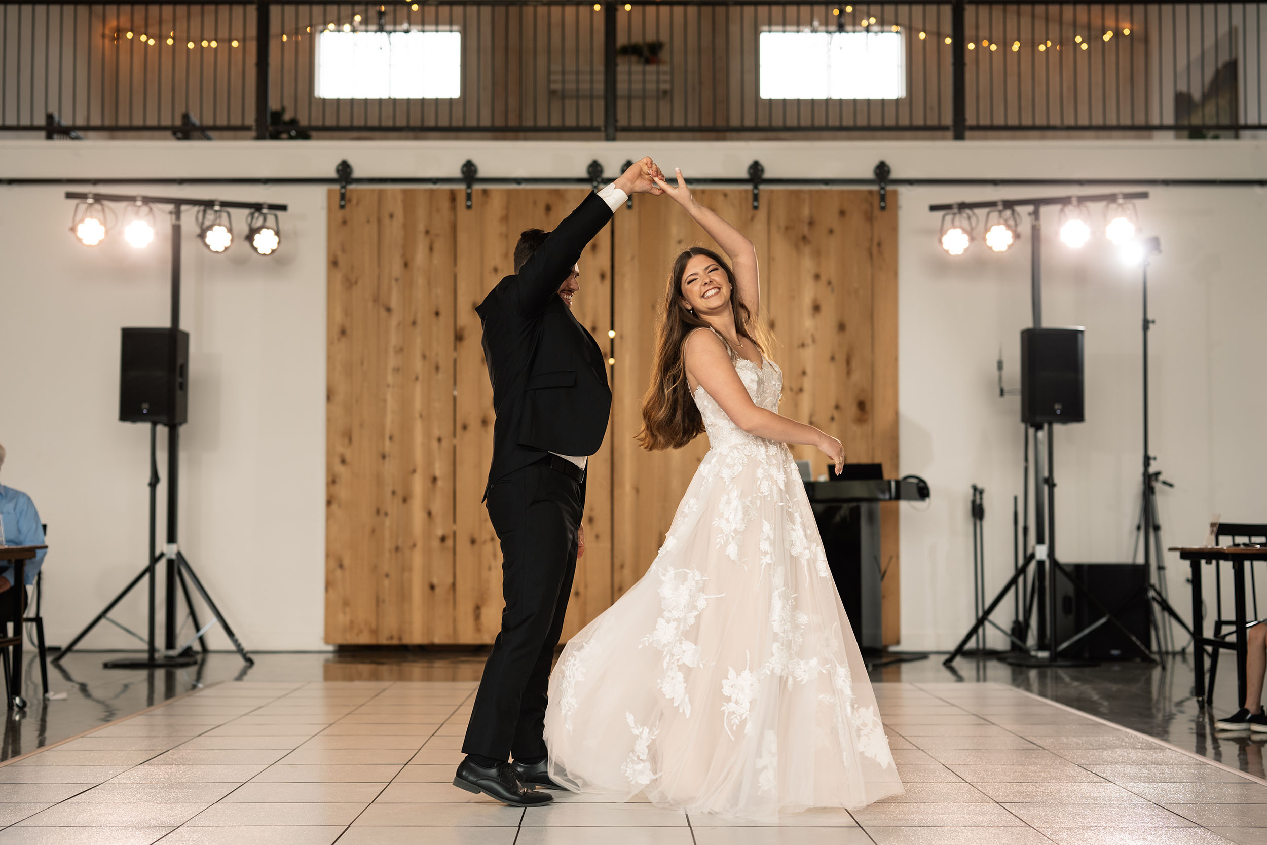 couple under twinkly light wedding arch brick wall olympic south side theater wedding venue cedar rapids