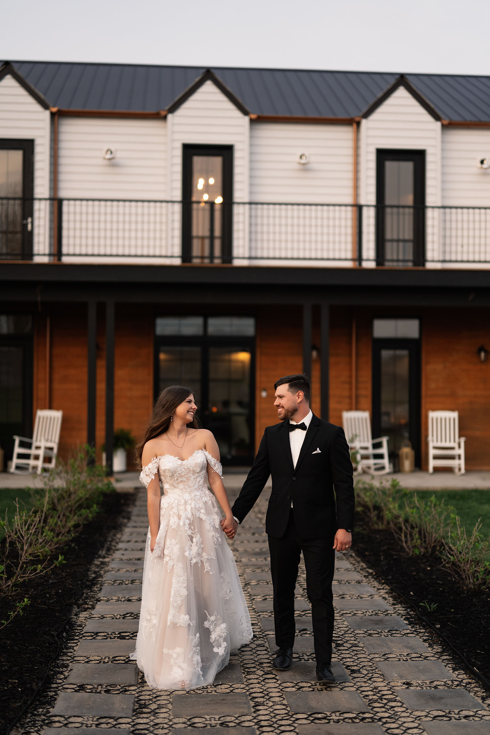 couple under twinkly light wedding arch brick wall olympic south side theater wedding venue cedar rapids