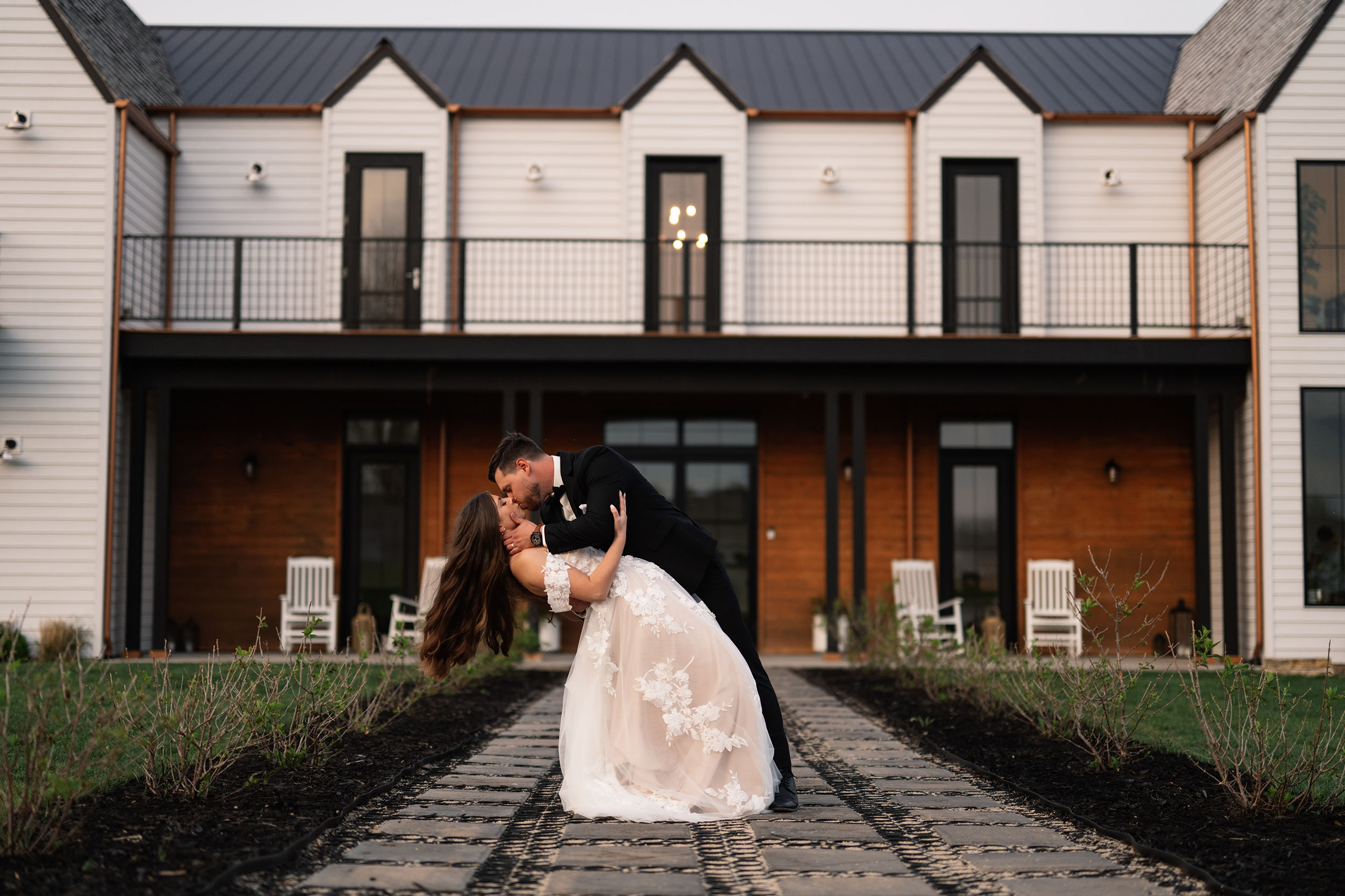 couple under twinkly light wedding arch brick wall olympic south side theater wedding venue cedar rapids