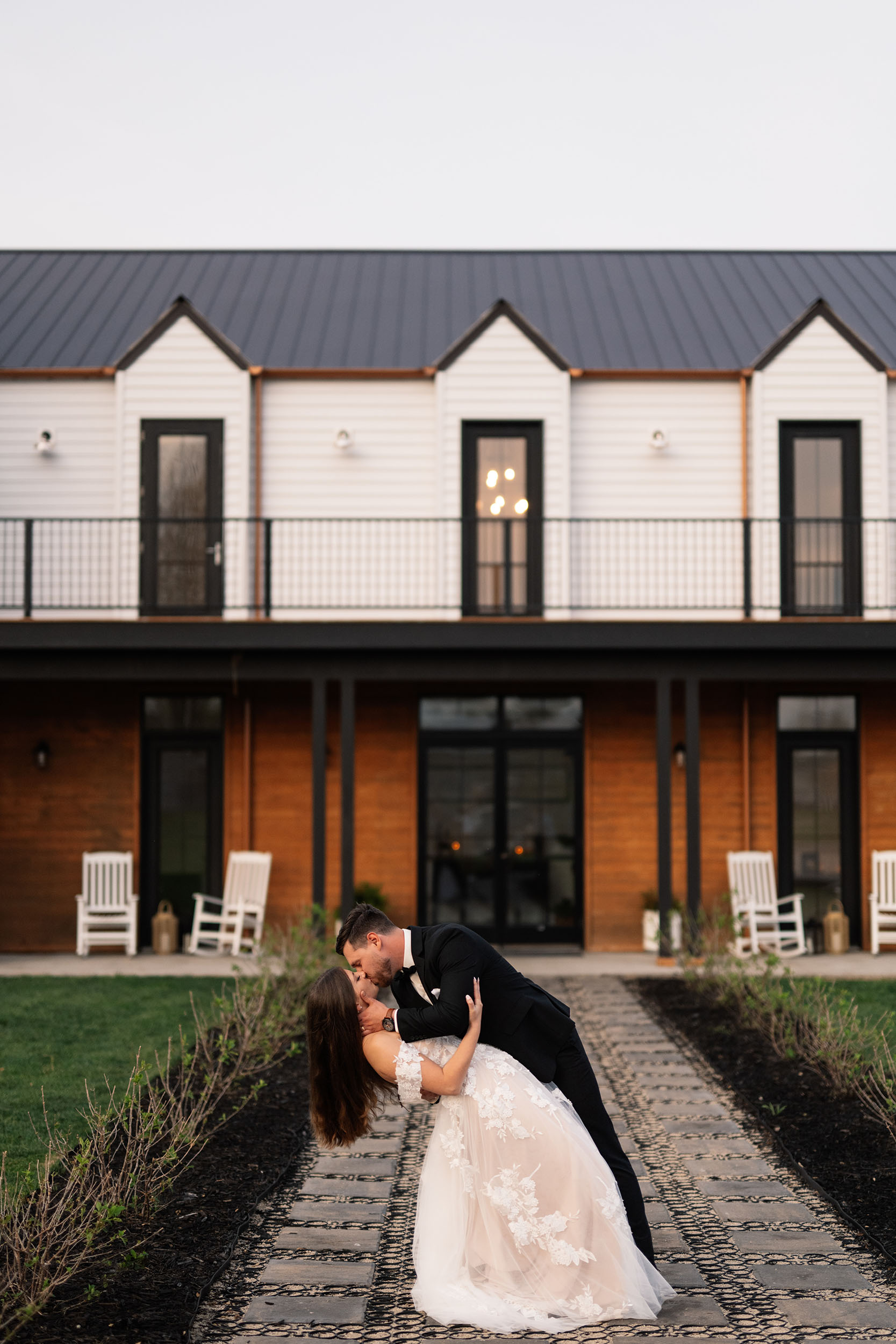 couple under twinkly light wedding arch brick wall olympic south side theater wedding venue cedar rapids