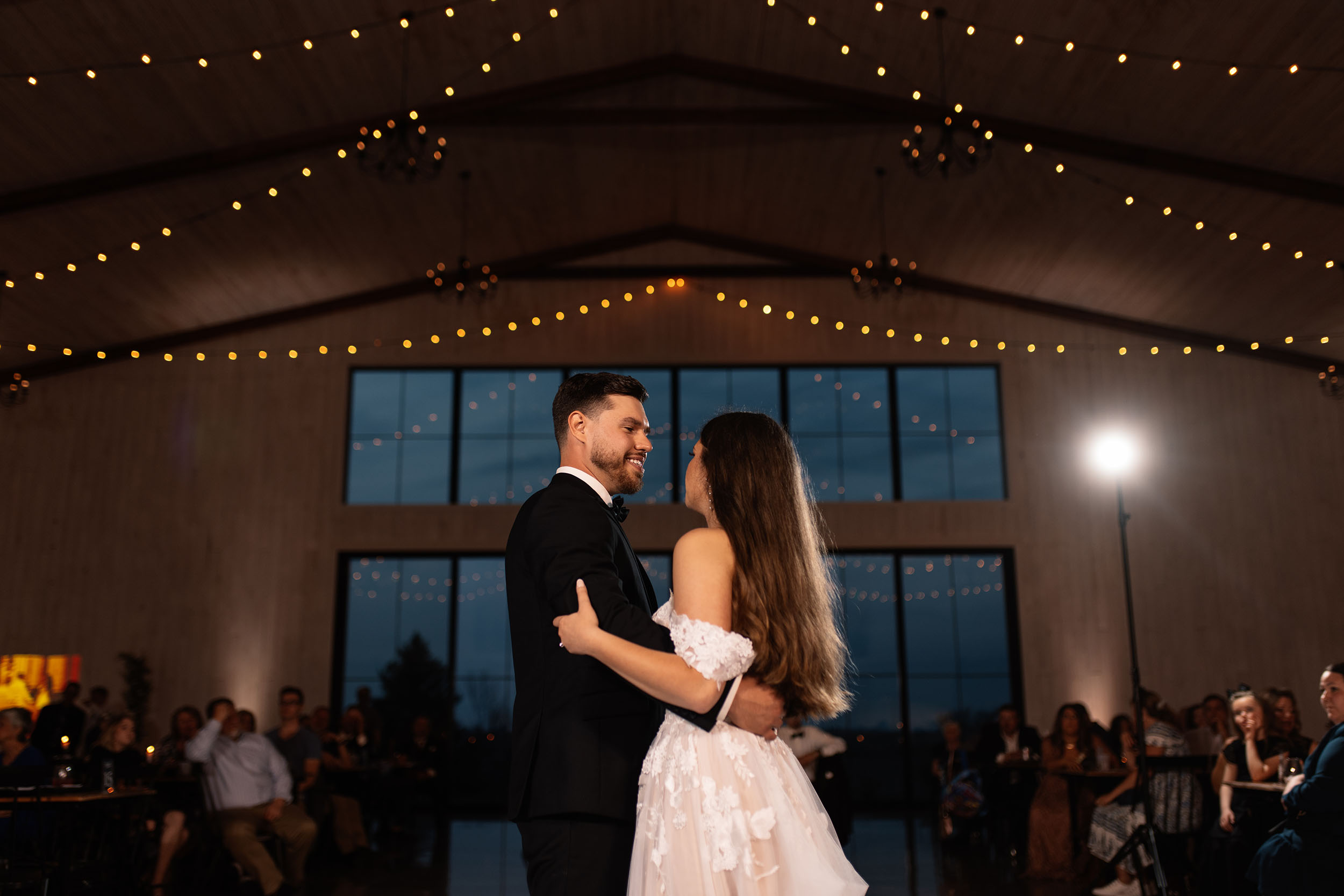 couple under twinkly light wedding arch brick wall olympic south side theater wedding venue cedar rapids