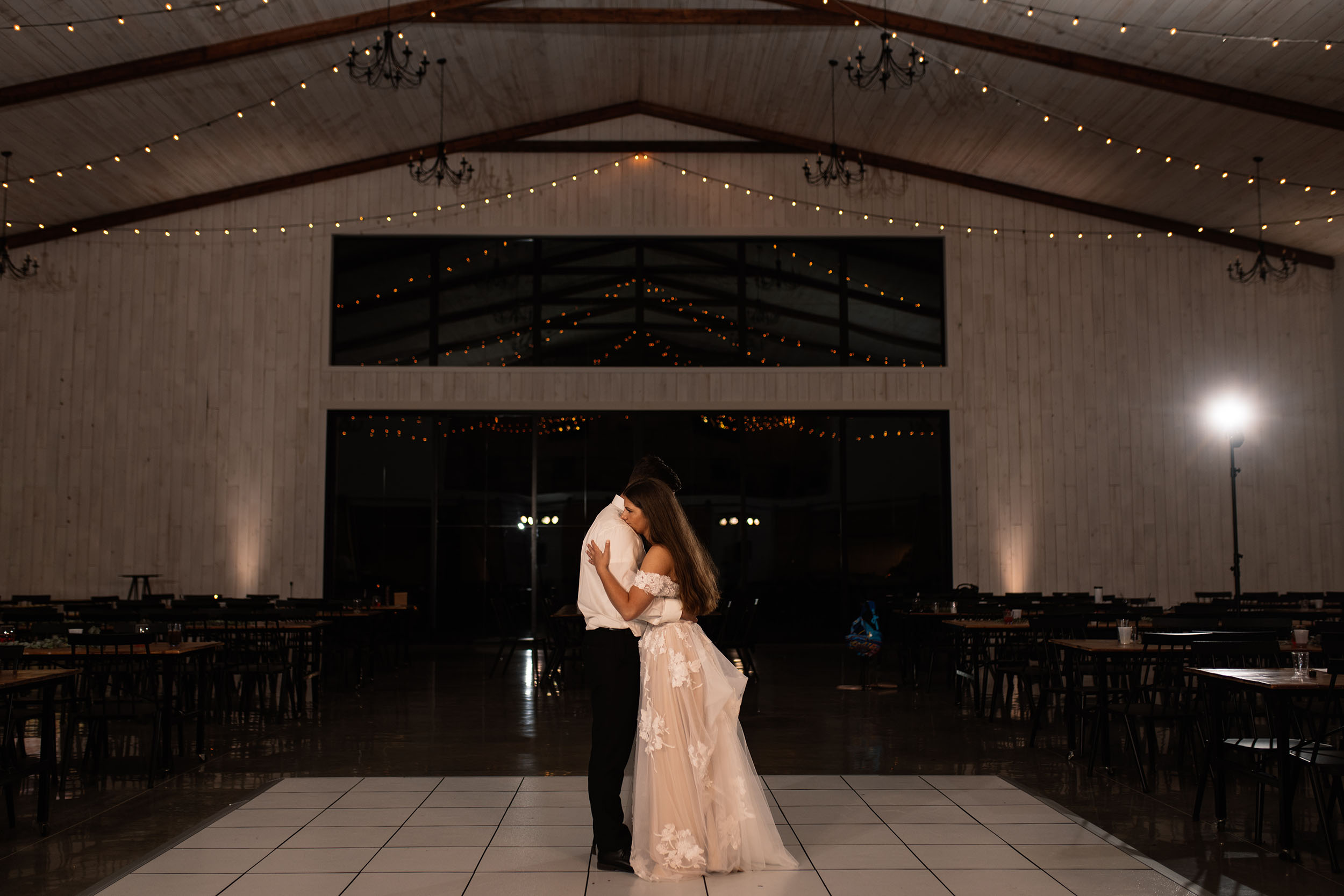 couple under twinkly light wedding arch brick wall olympic south side theater wedding venue cedar rapids