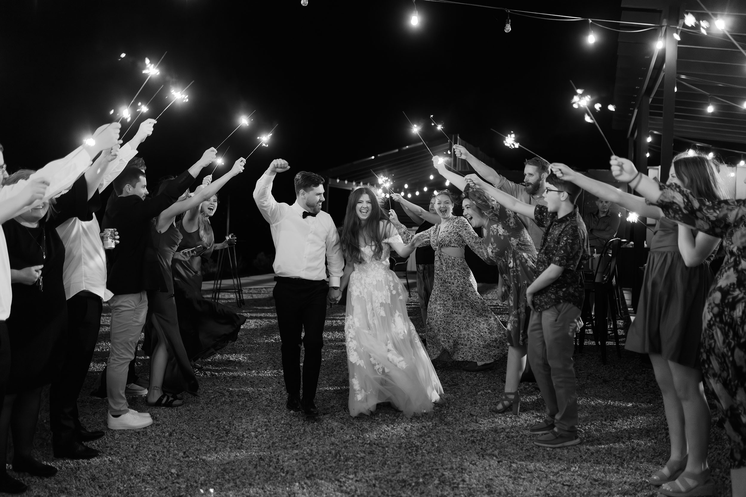 couple under twinkly light wedding arch brick wall olympic south side theater wedding venue cedar rapids