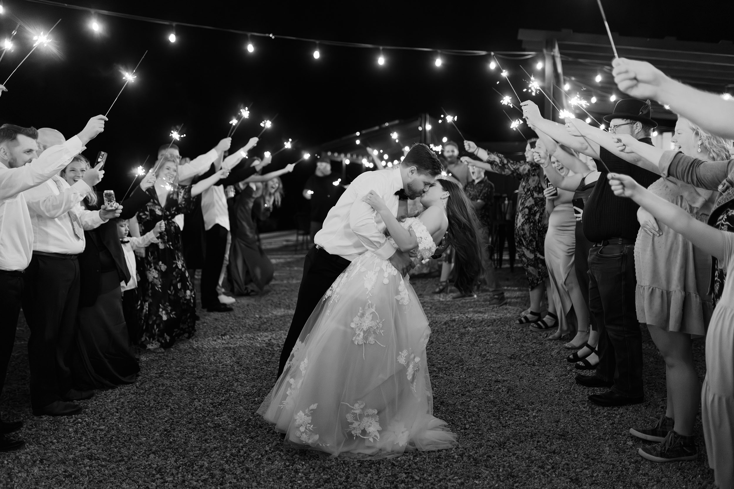 couple under twinkly light wedding arch brick wall olympic south side theater wedding venue cedar rapids