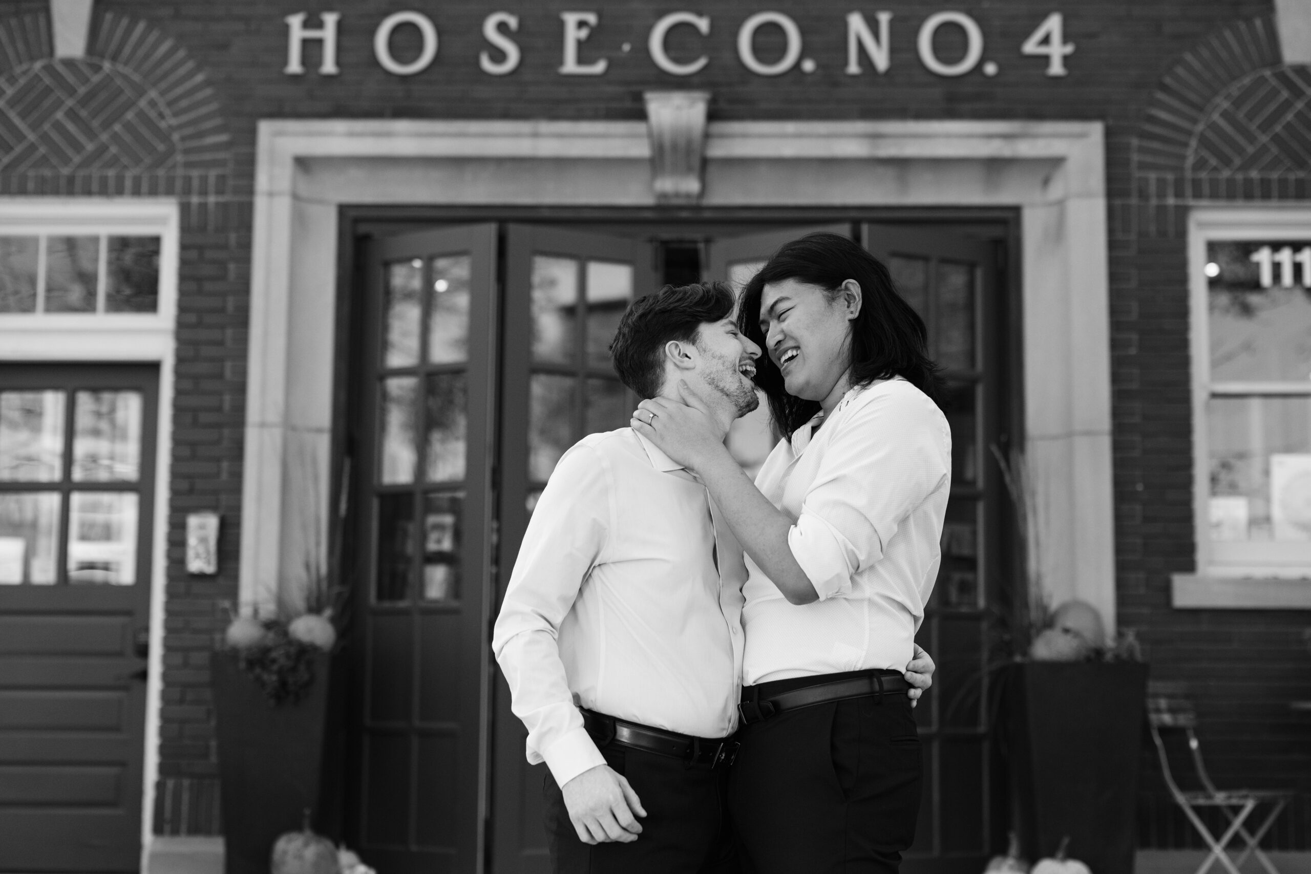 couple under twinkly light wedding arch brick wall olympic south side theater wedding venue cedar rapids