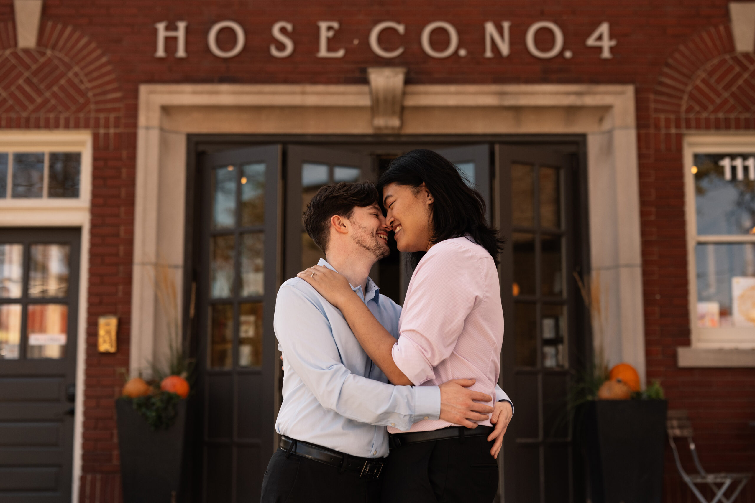 couple under twinkly light wedding arch brick wall olympic south side theater wedding venue cedar rapids