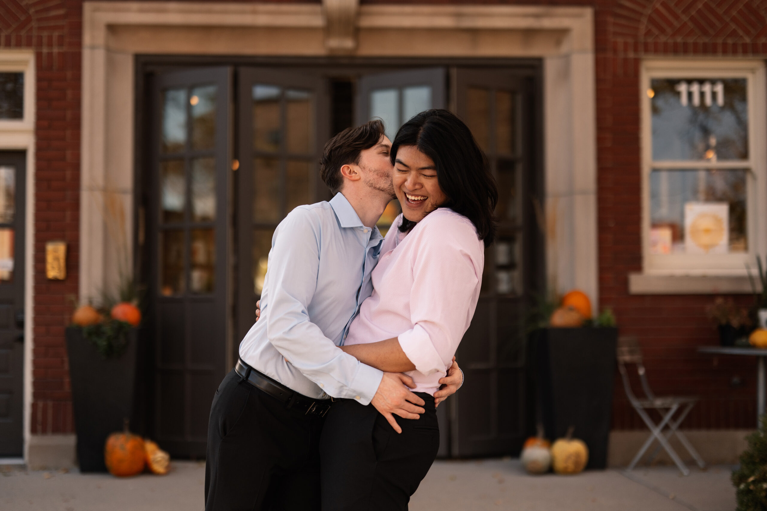 couple under twinkly light wedding arch brick wall olympic south side theater wedding venue cedar rapids