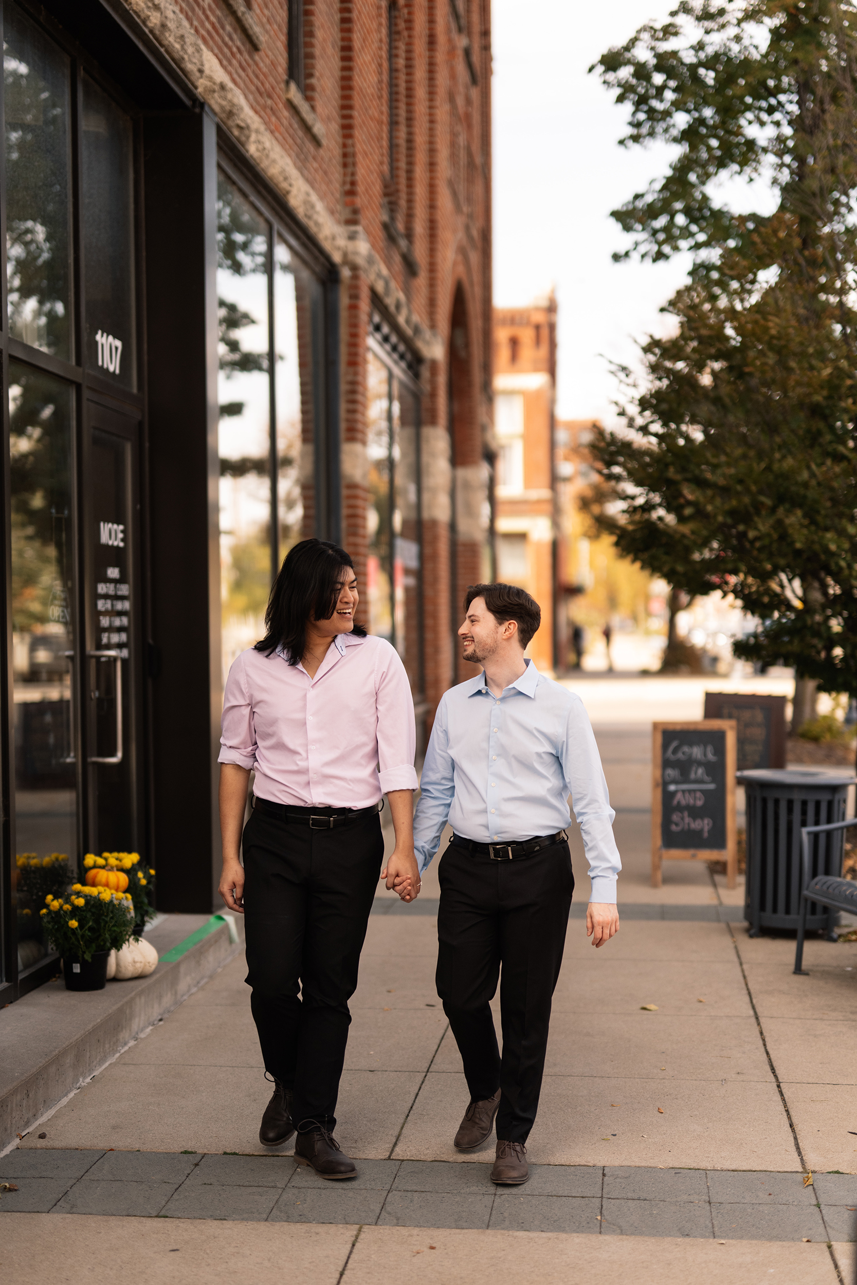 couple under twinkly light wedding arch brick wall olympic south side theater wedding venue cedar rapids