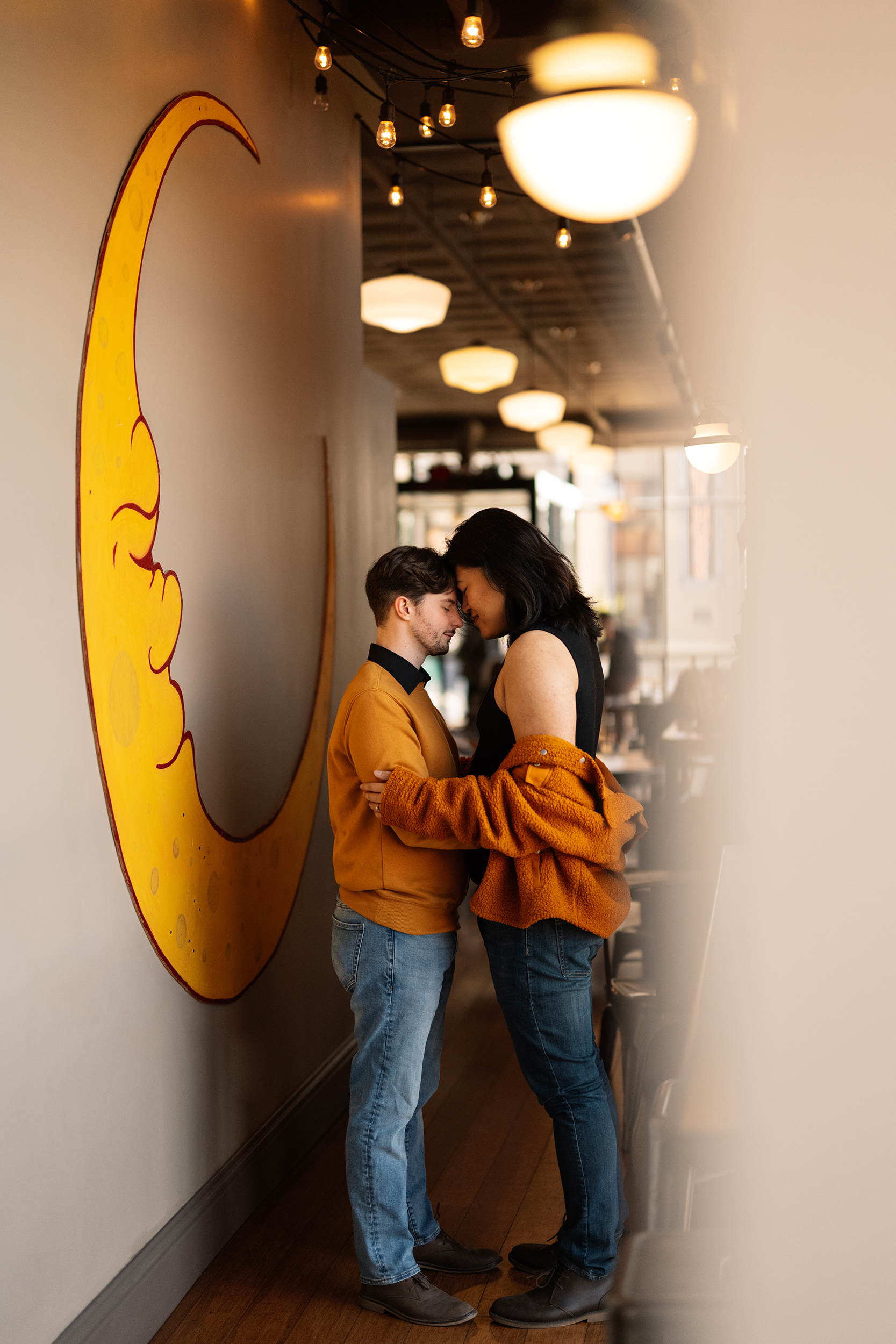 couple under twinkly light wedding arch brick wall olympic south side theater wedding venue cedar rapids