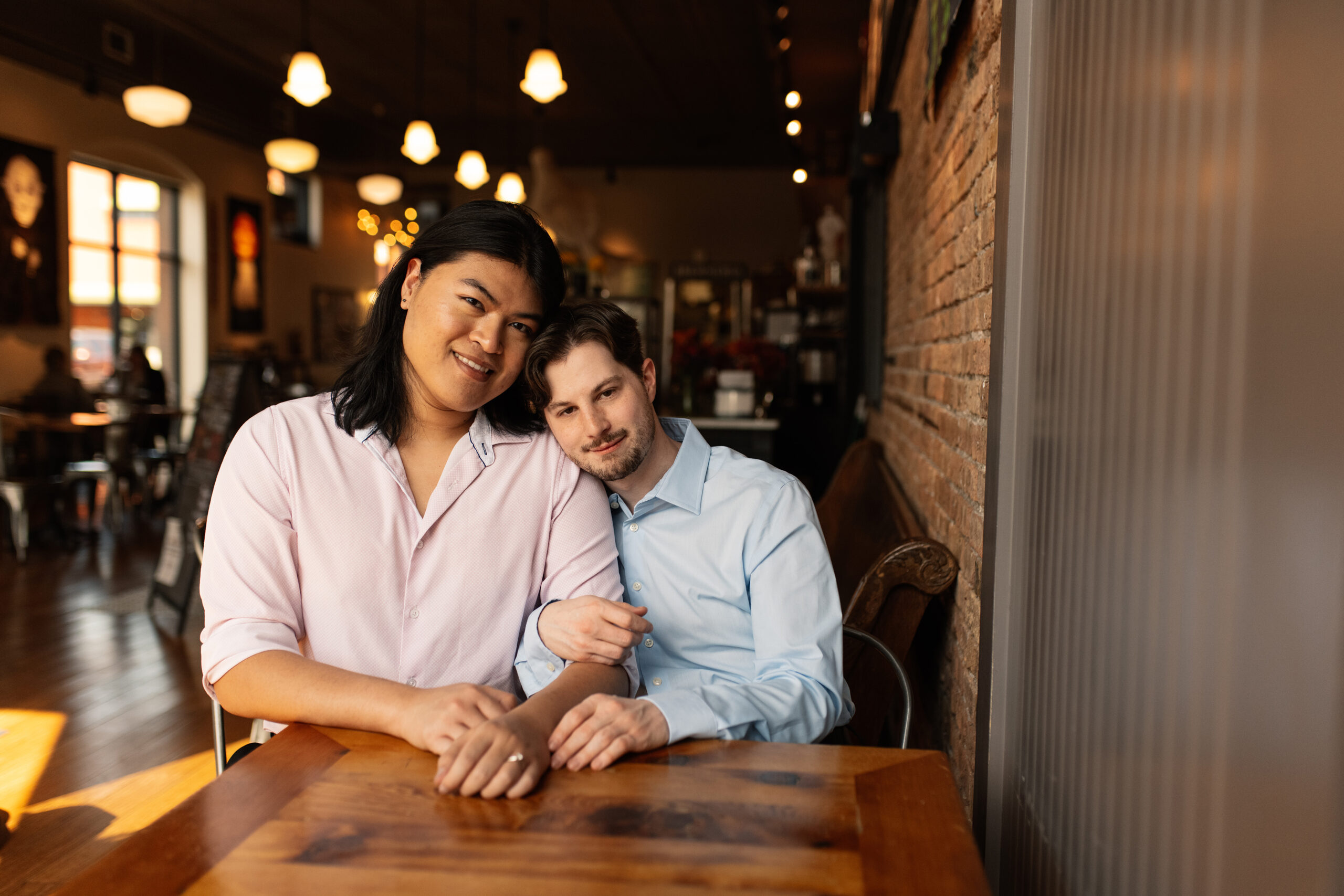 couple under twinkly light wedding arch brick wall olympic south side theater wedding venue cedar rapids