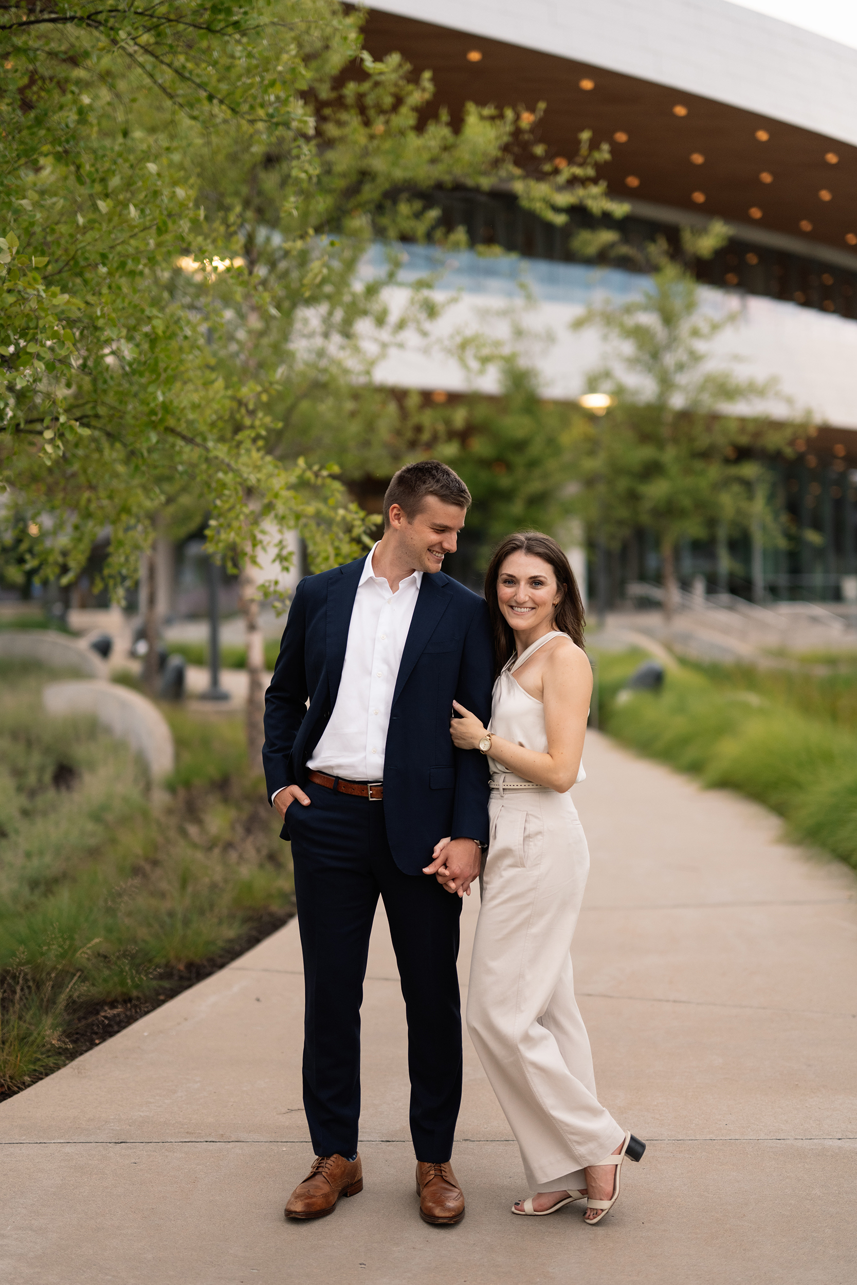 couple under twinkly light wedding arch brick wall olympic south side theater wedding venue cedar rapids