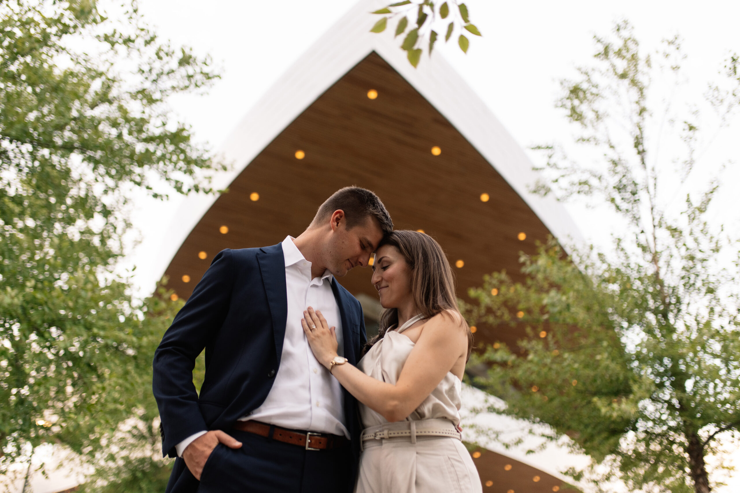 couple under twinkly light wedding arch brick wall olympic south side theater wedding venue cedar rapids