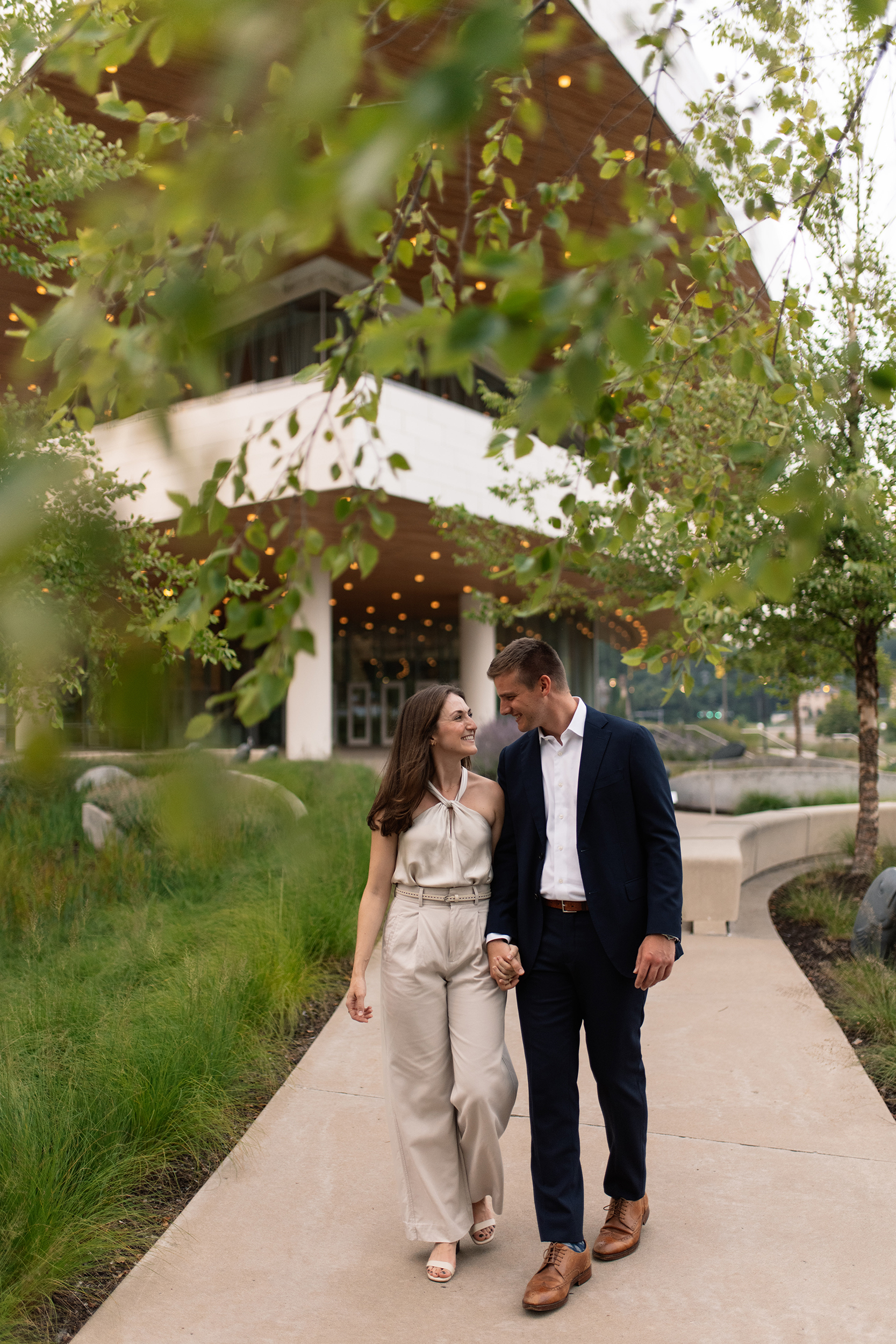 couple under twinkly light wedding arch brick wall olympic south side theater wedding venue cedar rapids