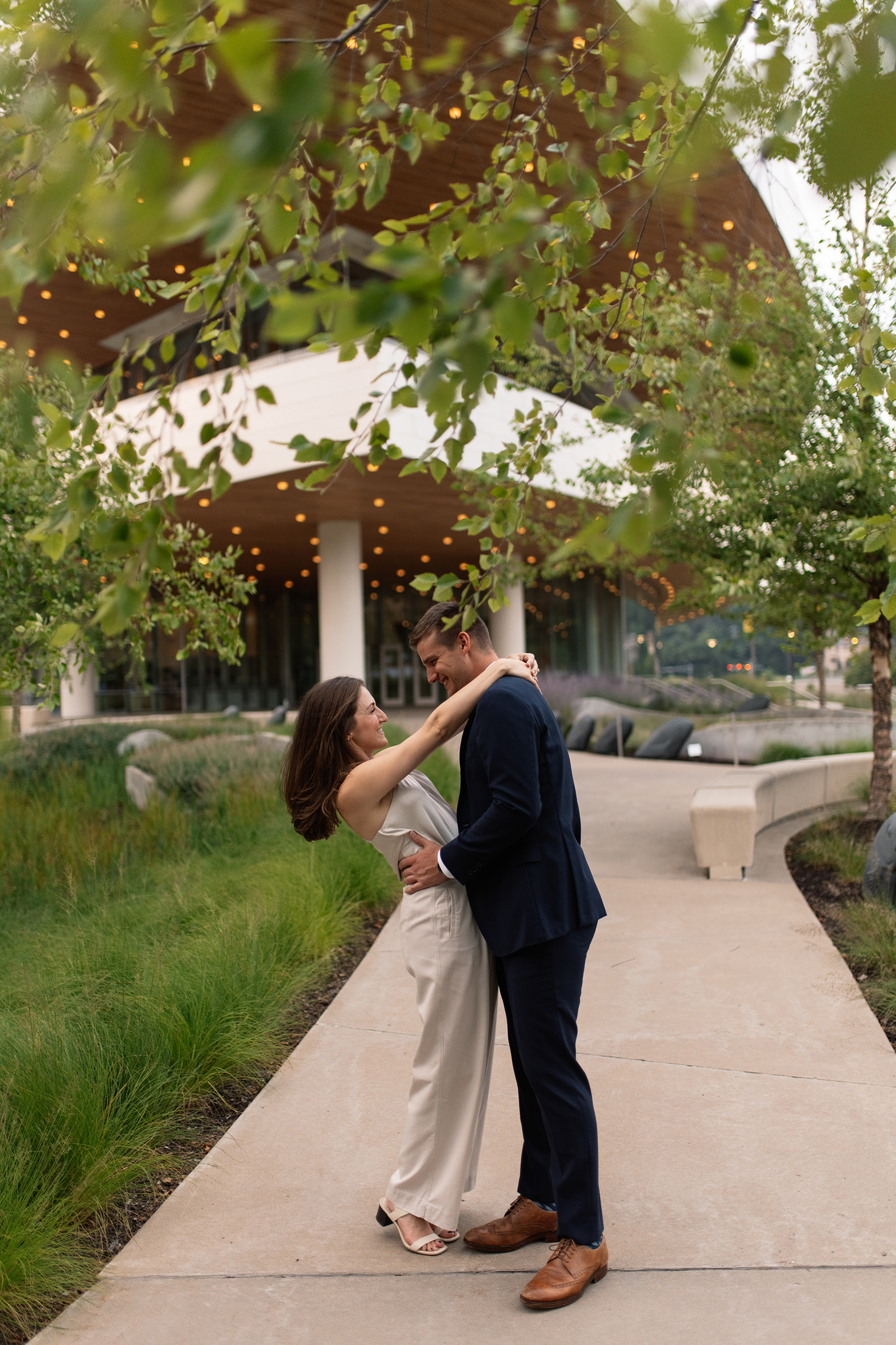 couple under twinkly light wedding arch brick wall olympic south side theater wedding venue cedar rapids