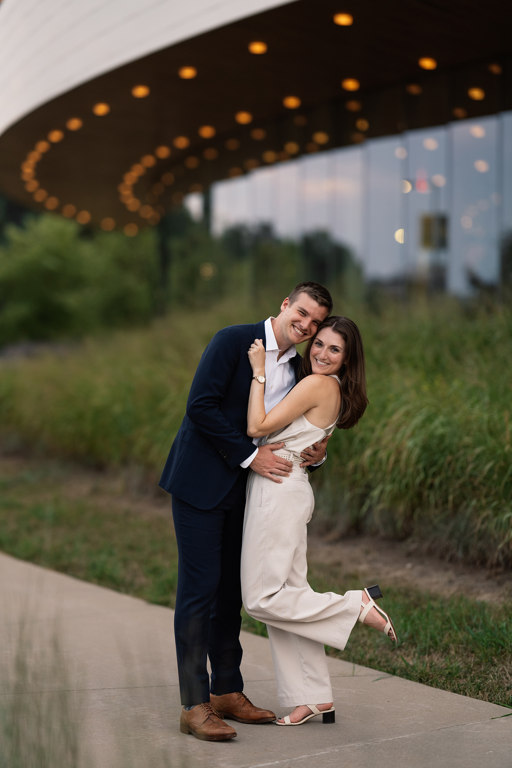 couple under twinkly light wedding arch brick wall olympic south side theater wedding venue cedar rapids