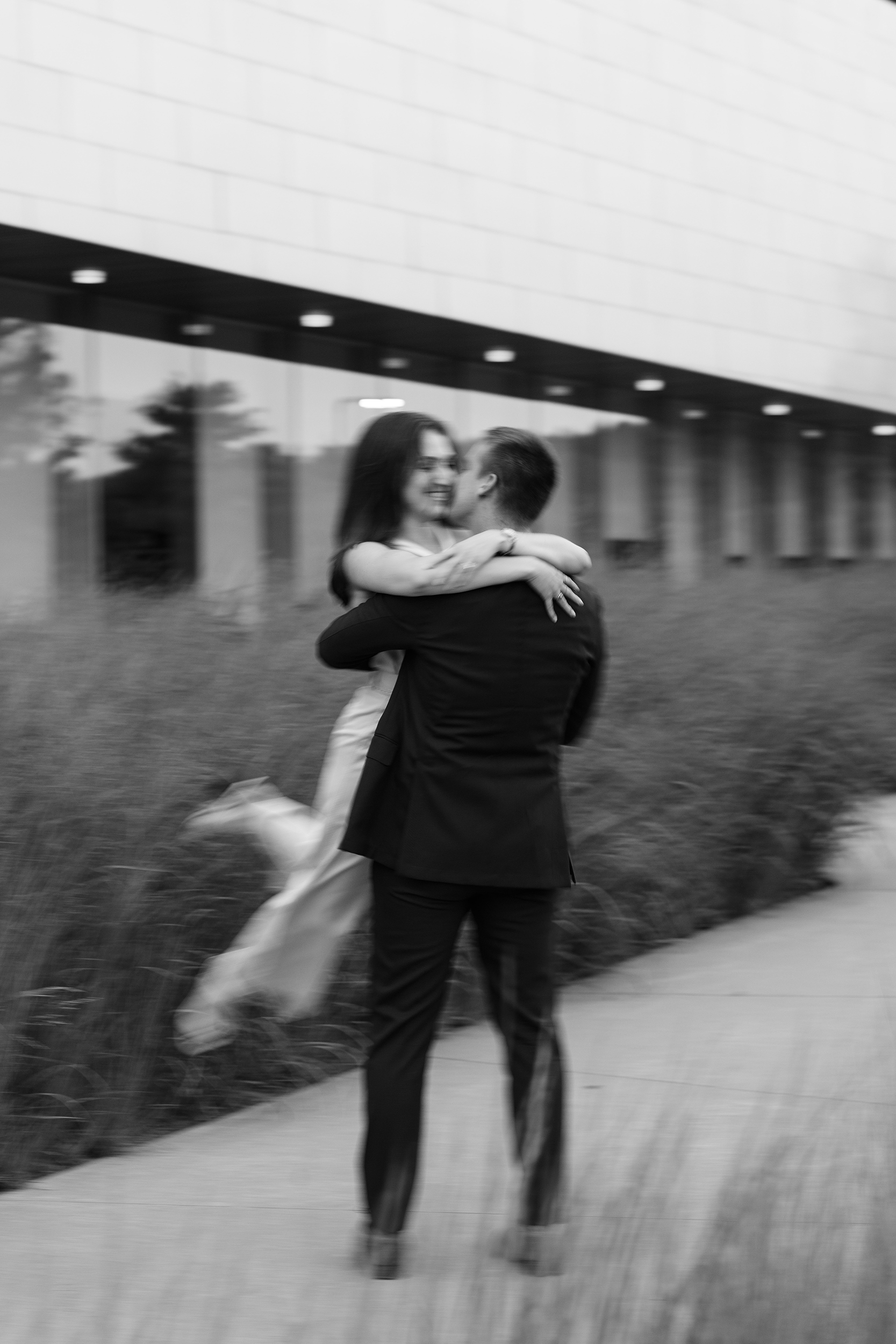 couple under twinkly light wedding arch brick wall olympic south side theater wedding venue cedar rapids