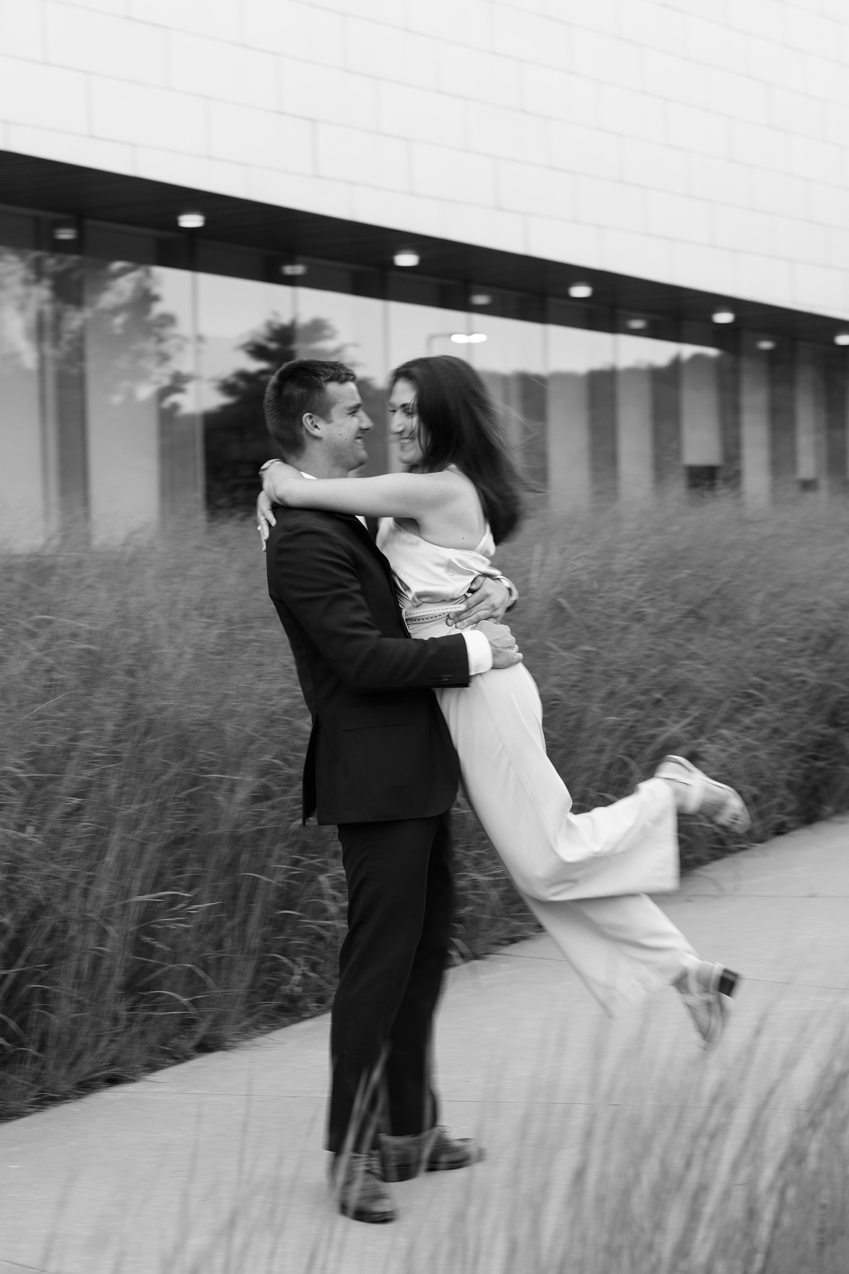 couple under twinkly light wedding arch brick wall olympic south side theater wedding venue cedar rapids