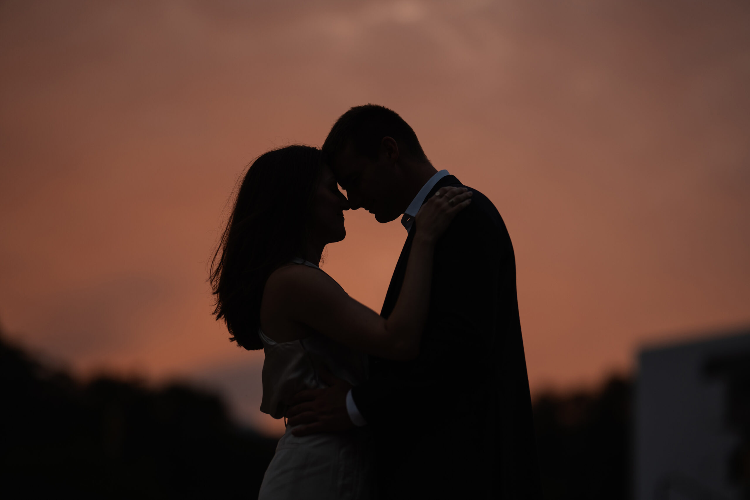 couple under twinkly light wedding arch brick wall olympic south side theater wedding venue cedar rapids