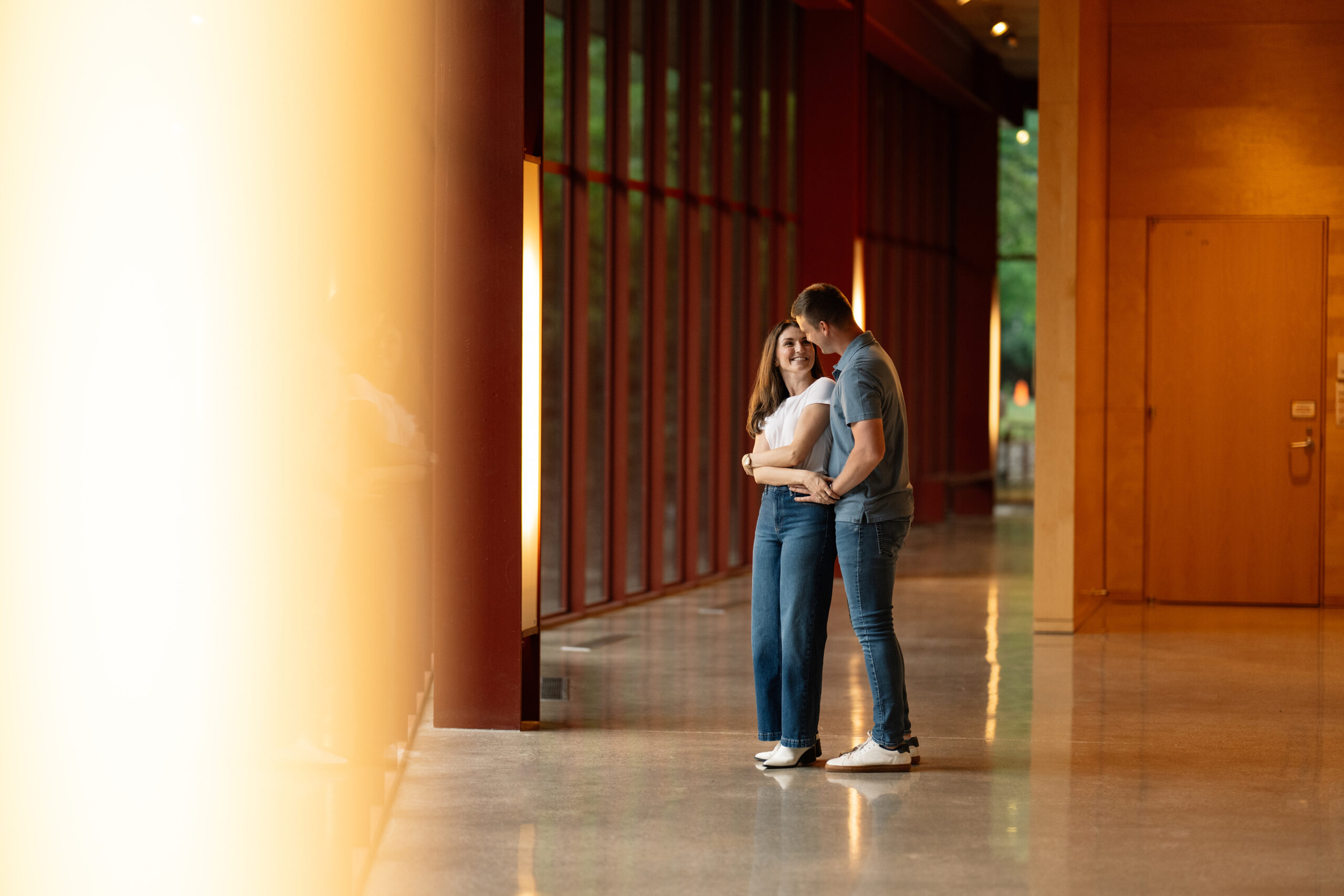 couple under twinkly light wedding arch brick wall olympic south side theater wedding venue cedar rapids