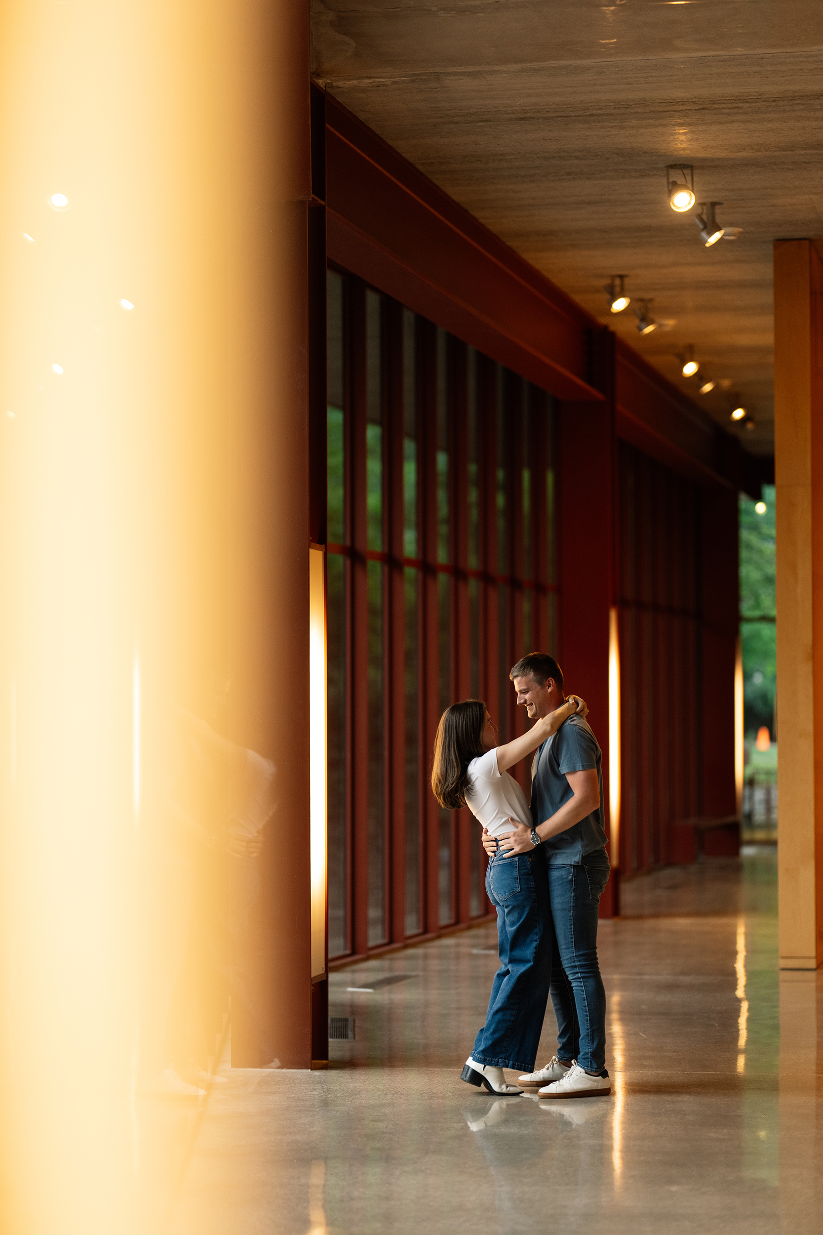 couple under twinkly light wedding arch brick wall olympic south side theater wedding venue cedar rapids