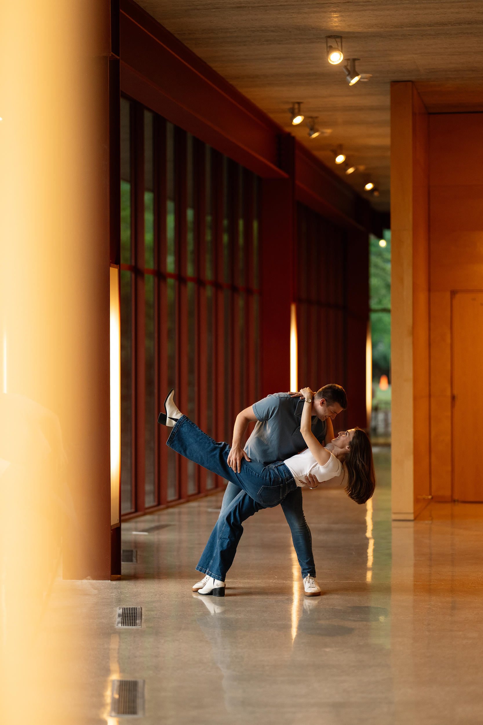 couple under twinkly light wedding arch brick wall olympic south side theater wedding venue cedar rapids